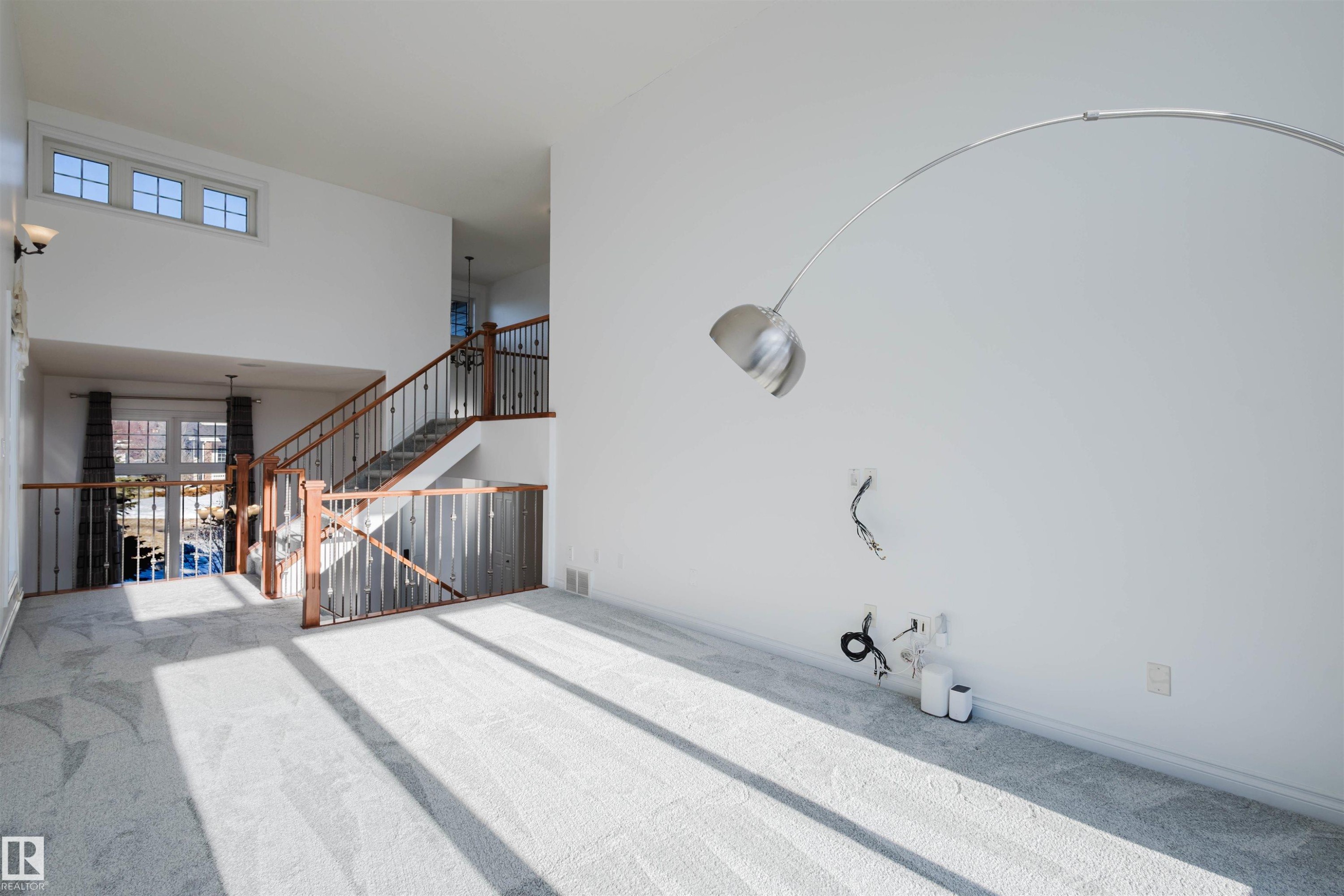 Unfurnished living room featuring a high ceiling and carpet floors - 3547 Mclay Crescent, Edmonton, AB - Photo Showing Other Room