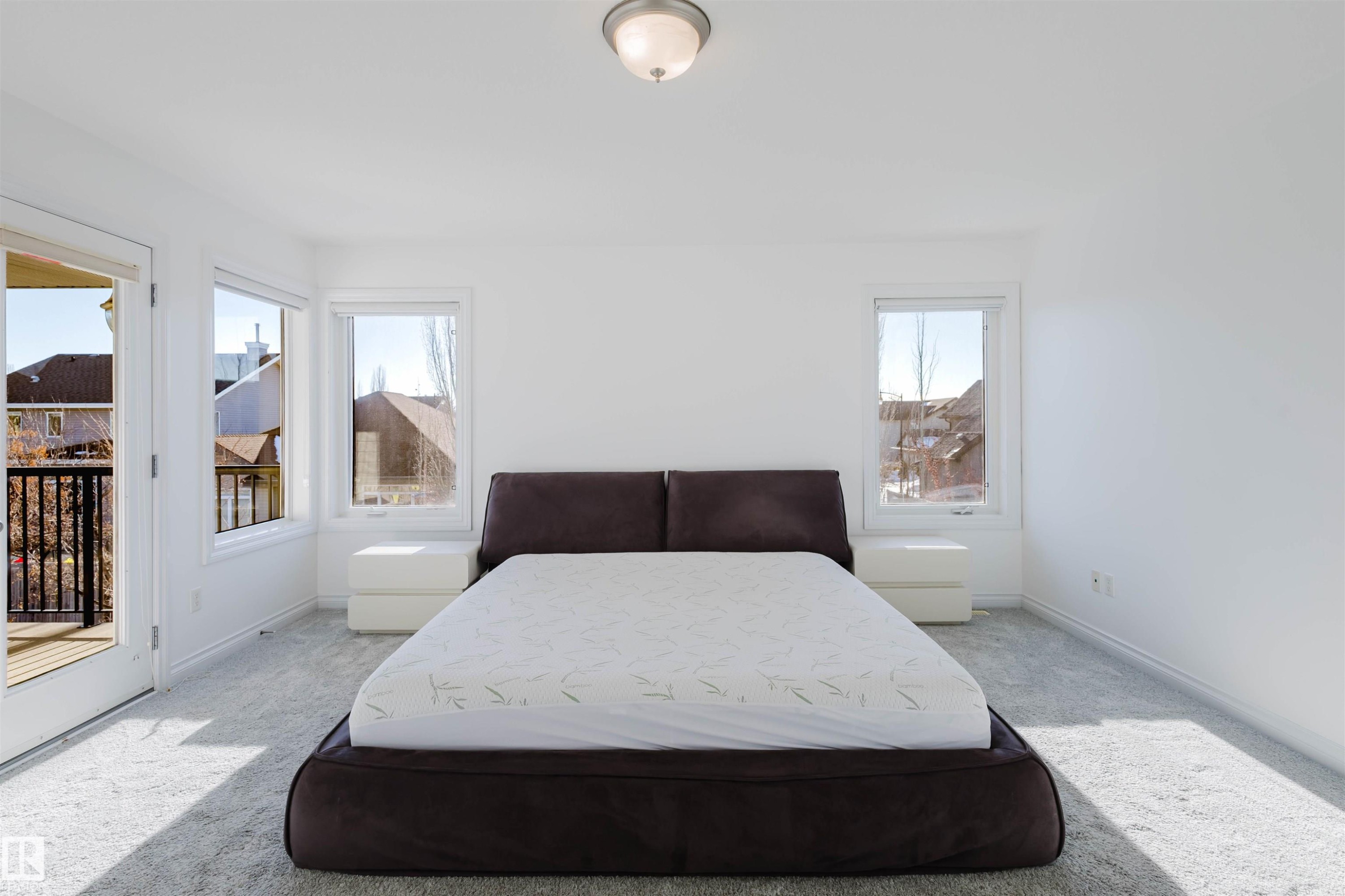 Bedroom with carpet flooring and access to outside - 3547 Mclay Crescent, Edmonton, AB - Indoor Photo Showing Bedroom