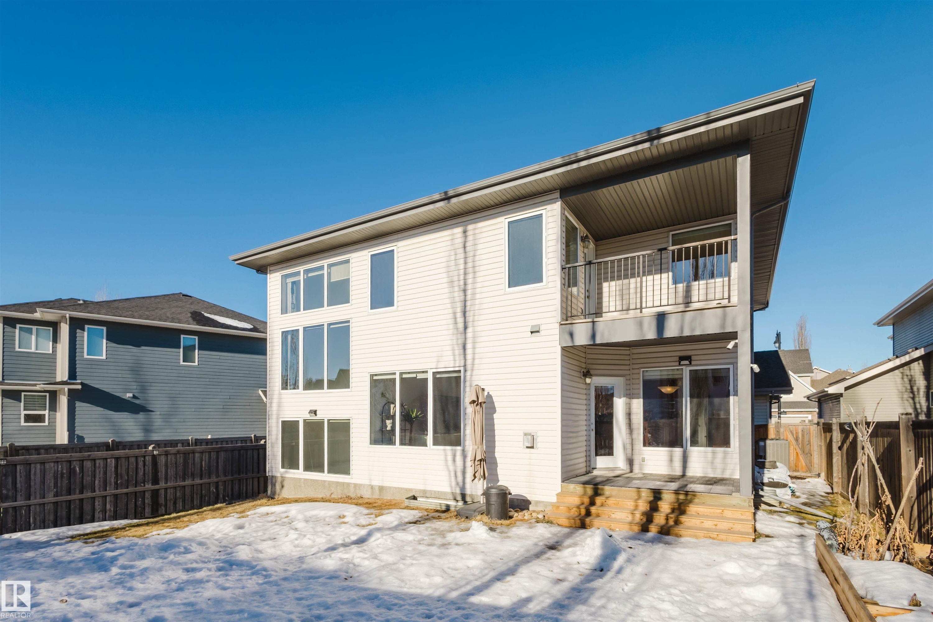 Snow covered rear of property featuring a fenced backyard and a balcony - 3547 Mclay Crescent, Edmonton, AB - Outdoor With Balcony