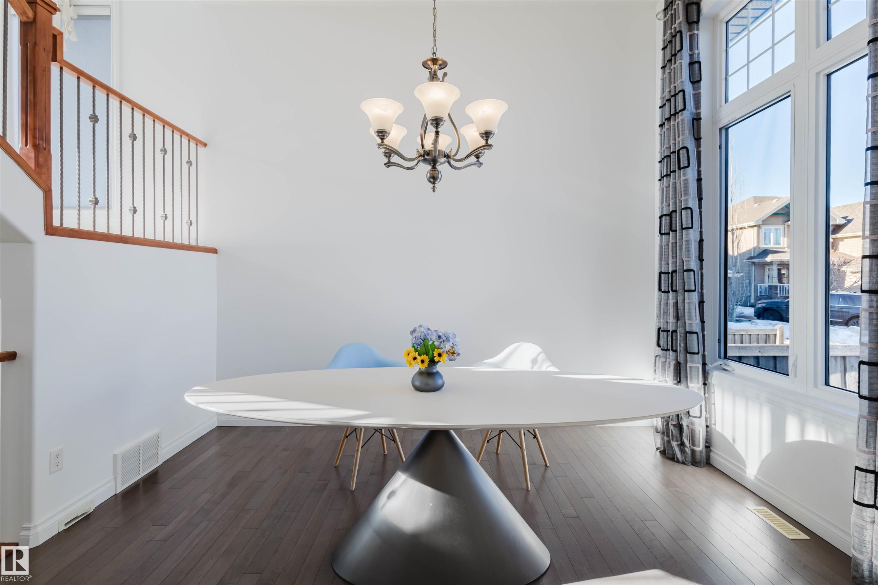 Dining area with dark wood finished floors and suspended lighting - 3547 Mclay Crescent, Edmonton, AB - Indoor Photo Showing Dining Room