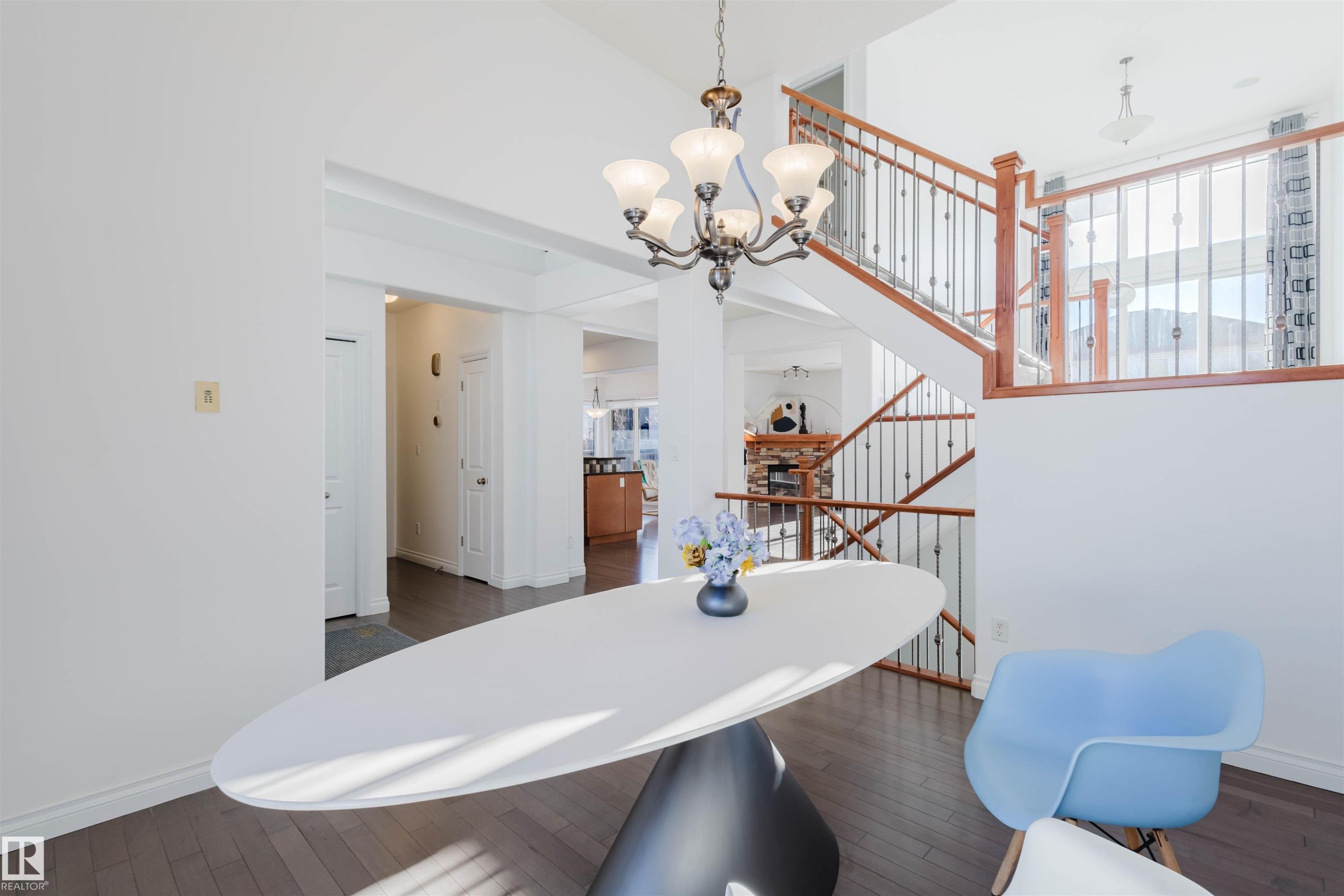 Dining area with dark wood-style flooring, a high ceiling, and a chandelier - 3547 Mclay Crescent, Edmonton, AB - Indoor Photo Showing Other Room