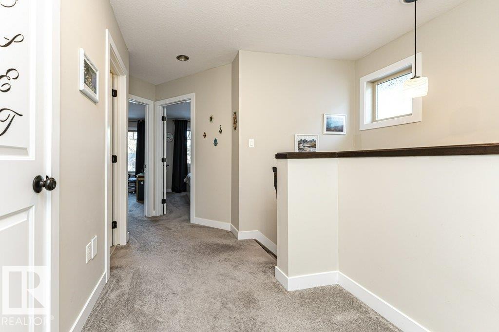 Hallway with light colored carpet and a textured ceiling - 10535 67 Avenue, Edmonton, AB - Indoor Photo Showing Other Room