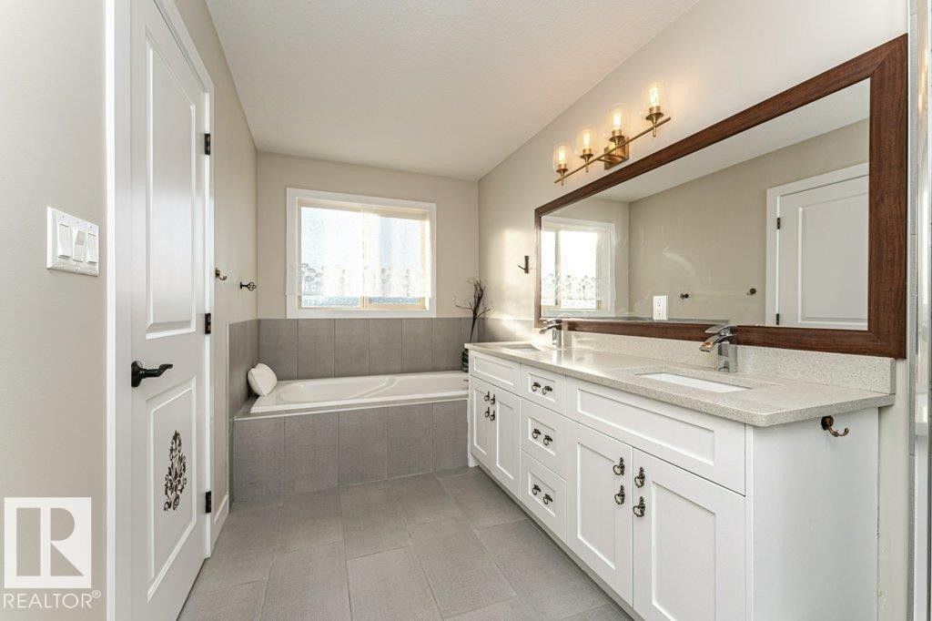 Full bathroom with double vanity, a garden tub, and light tile patterned flooring - 10535 67 Avenue, Edmonton, AB - Indoor Photo Showing Bathroom
