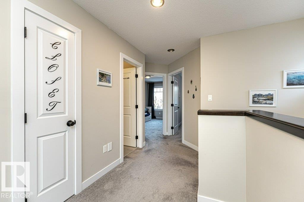 Hallway with light colored carpet and a textured ceiling - 10535 67 Avenue, Edmonton, AB - Indoor Photo Showing Other Room