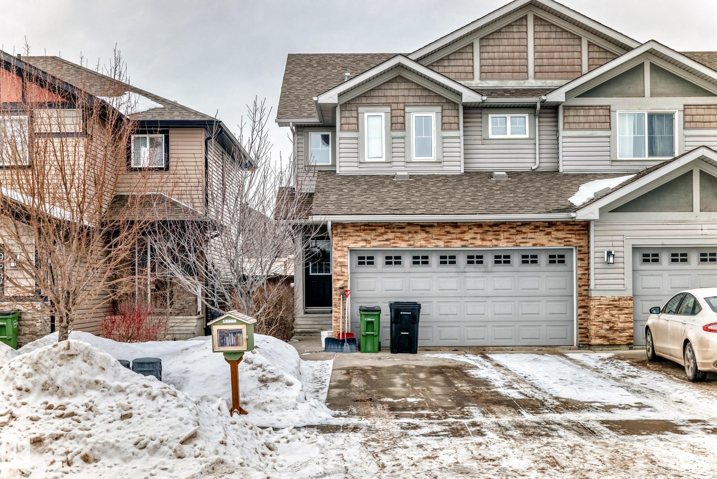 Craftsman house with a shingled roof, an attached garage, and driveway - 9645 Simpson Place, Edmonton, AB