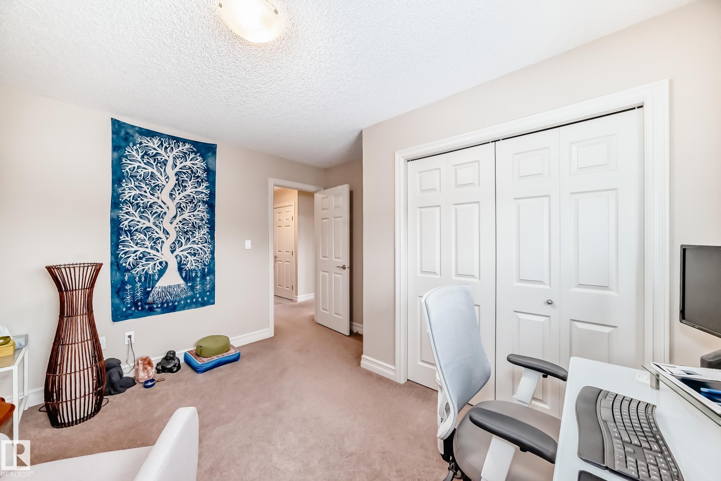 Carpeted home office featuring a textured ceiling and baseboards - 9645 Simpson Place, Edmonton, AB