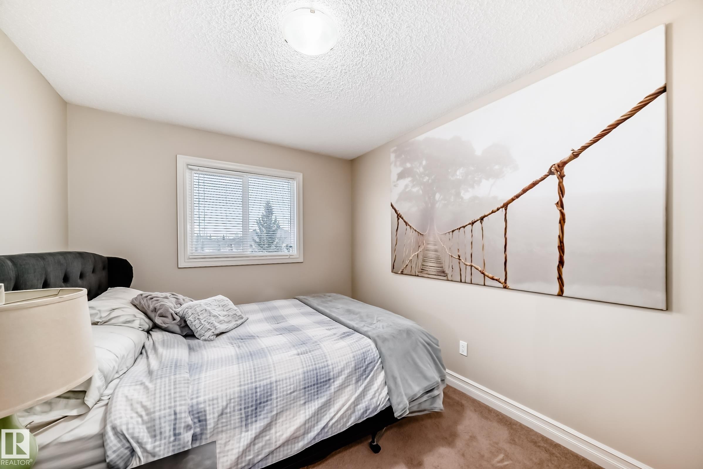 Bedroom featuring carpet and a textured ceiling - 9645 Simpson Place, Edmonton, AB