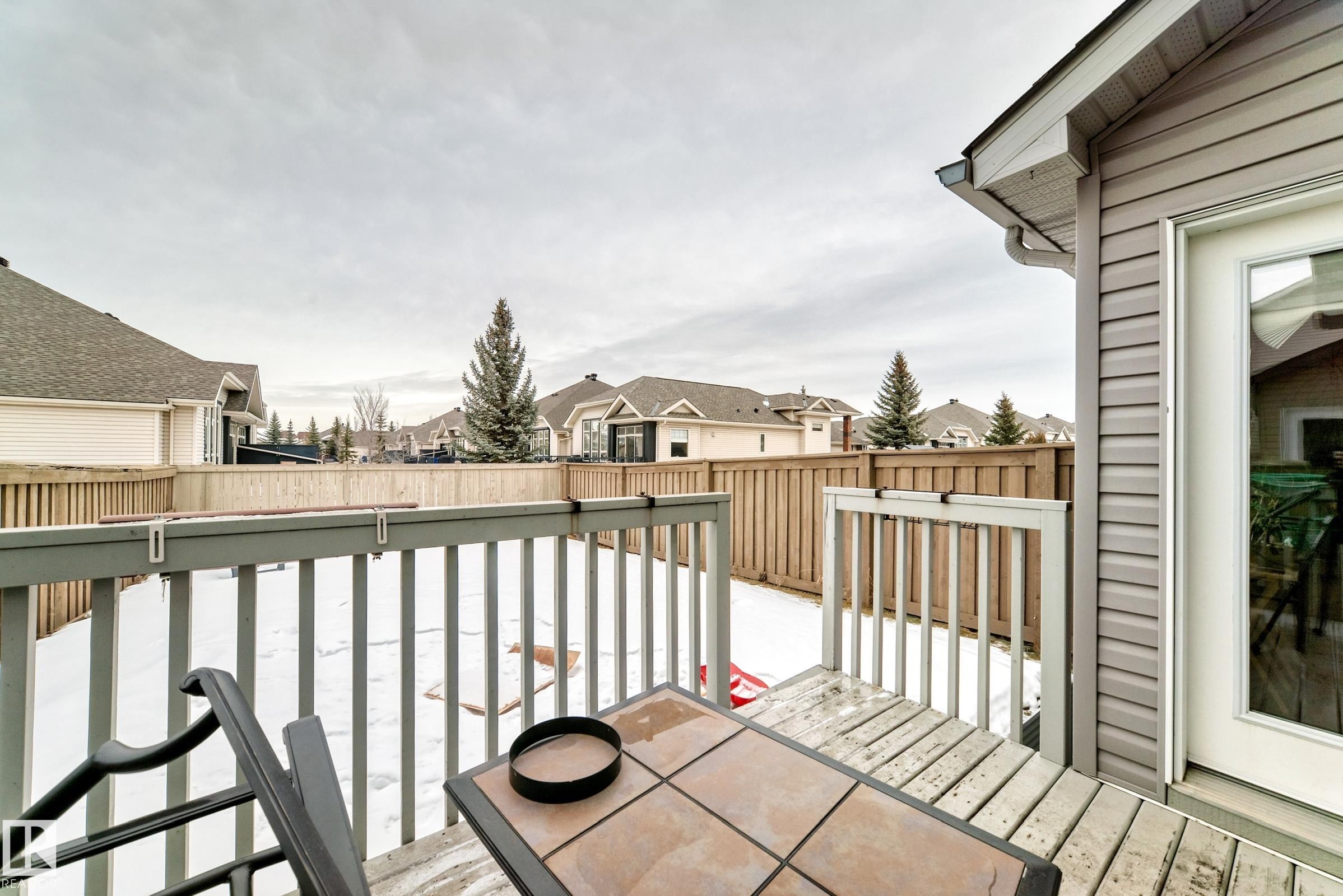 View of wooden balcony with a residential view and a deck - 9645 Simpson Place, Edmonton, AB