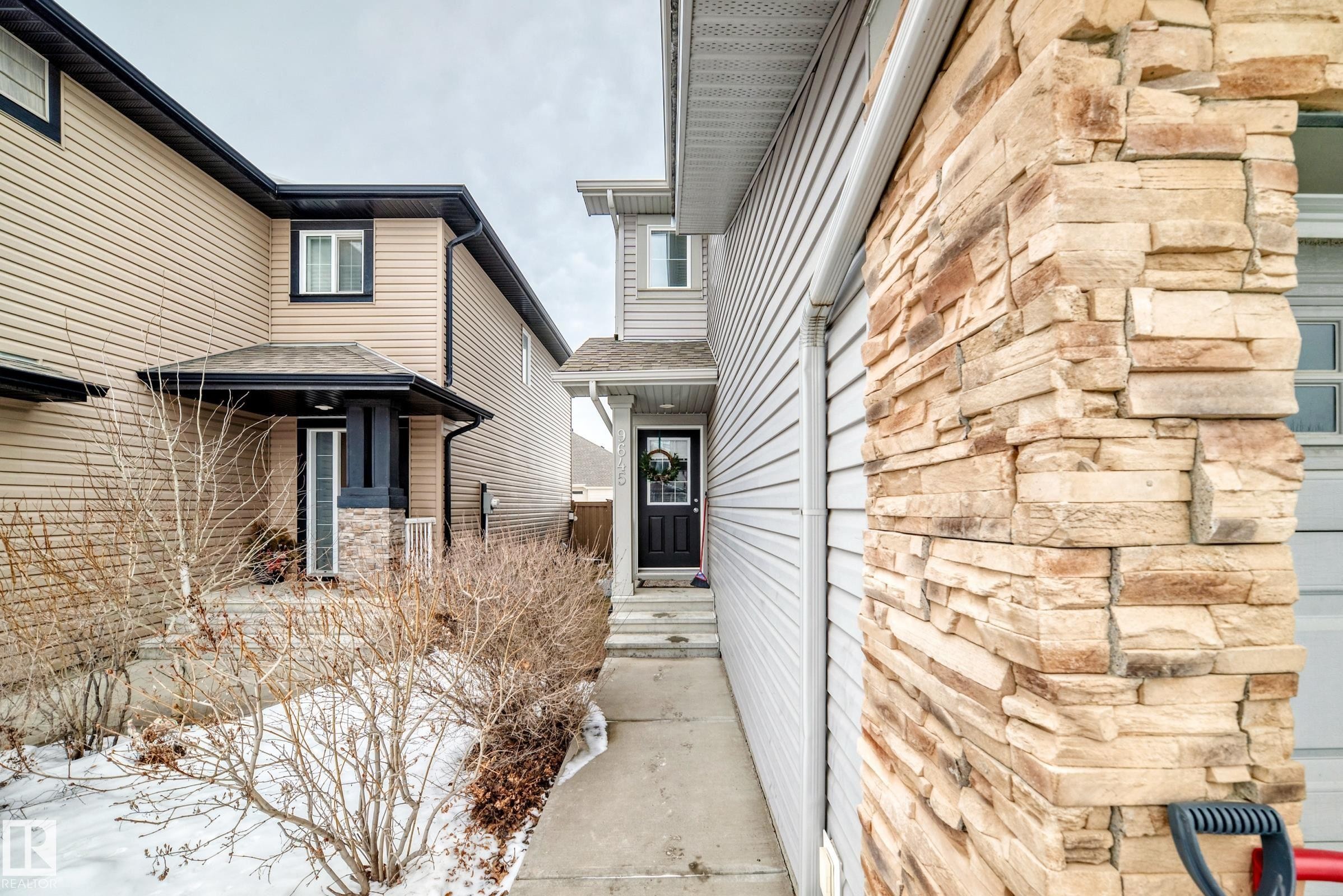 Doorway to property with stone siding - 9645 Simpson Place, Edmonton, AB