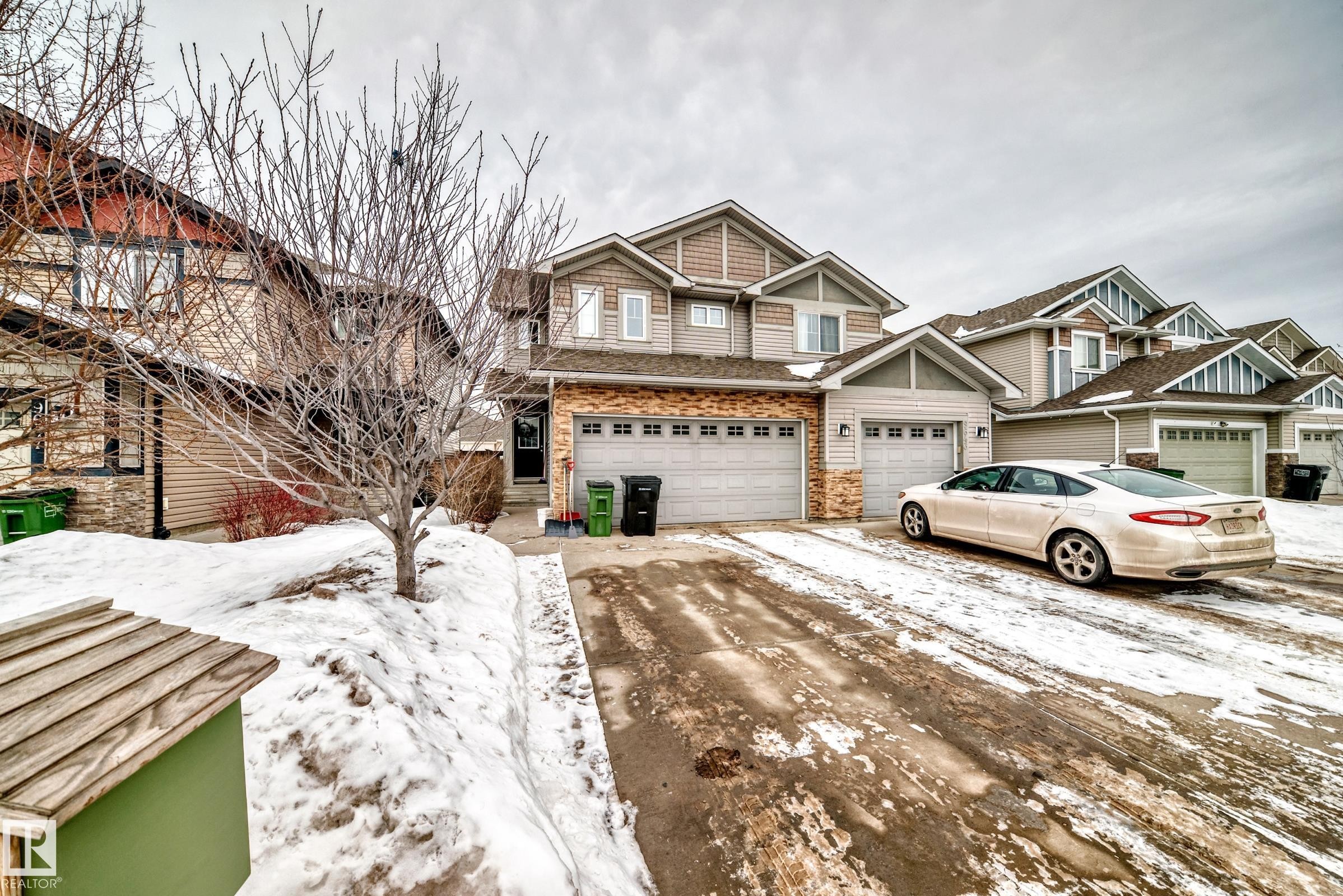Craftsman-style home featuring driveway and an attached garage - 9645 Simpson Place, Edmonton, AB