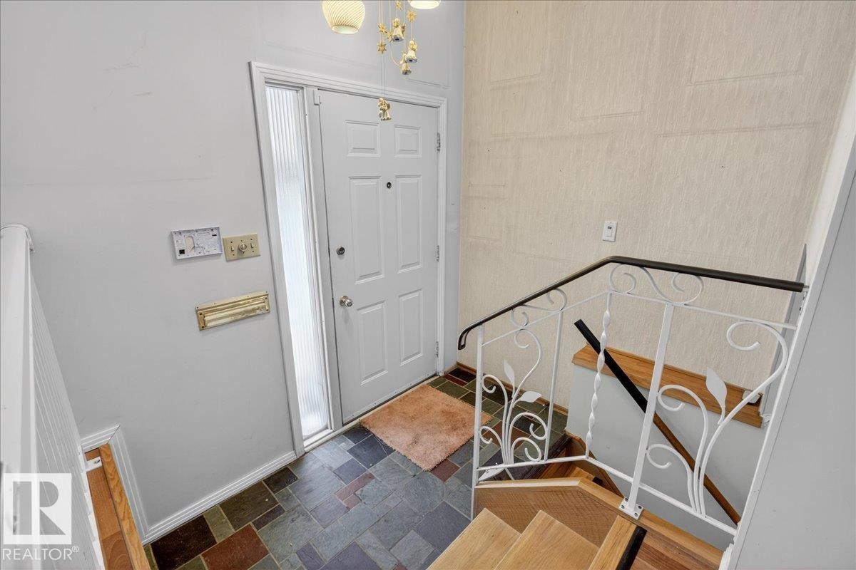 Entryway featuring suspended lighting and baseboards - Edmonton, AB - Indoor Photo Showing Other Room