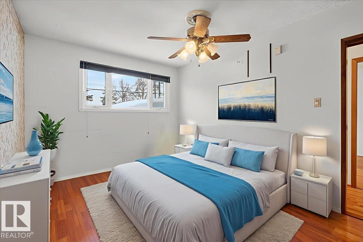 Bedroom featuring wood finished floors and ceiling fan - Edmonton, AB - Indoor Photo Showing Bedroom