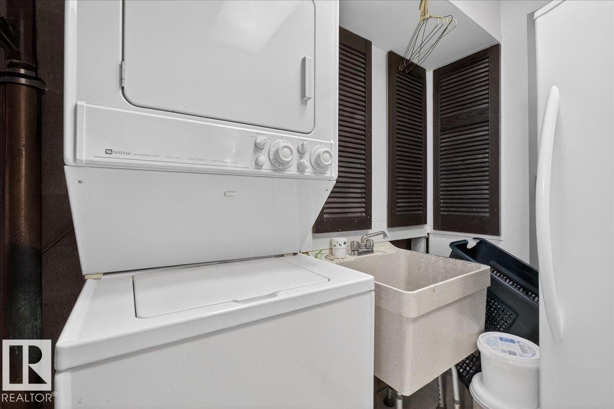 Laundry room with stacked washer / dryer - Edmonton, AB - Indoor Photo Showing Laundry Room