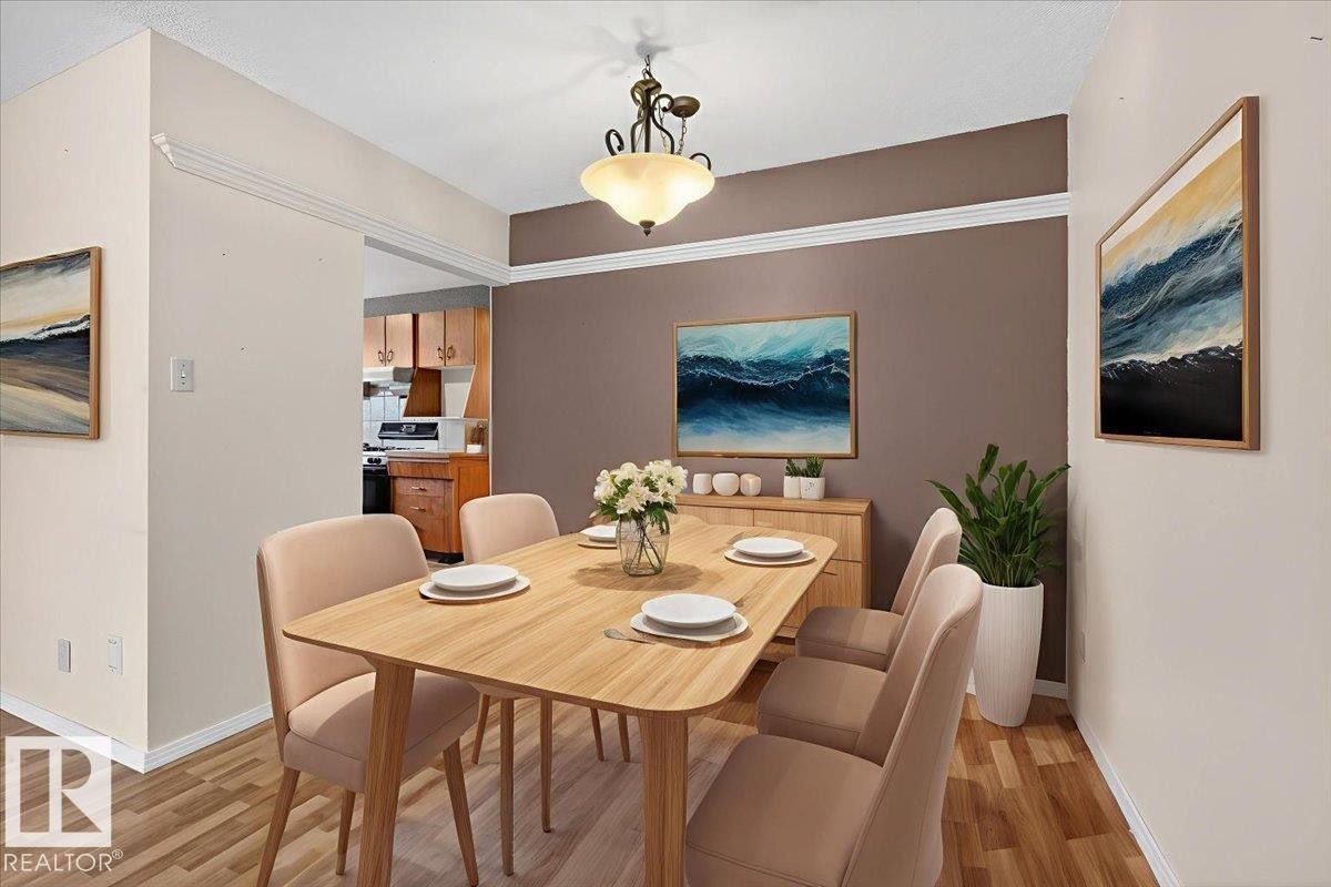 Dining area featuring baseboards and light wood-style floors - Edmonton, AB - Indoor Photo Showing Dining Room