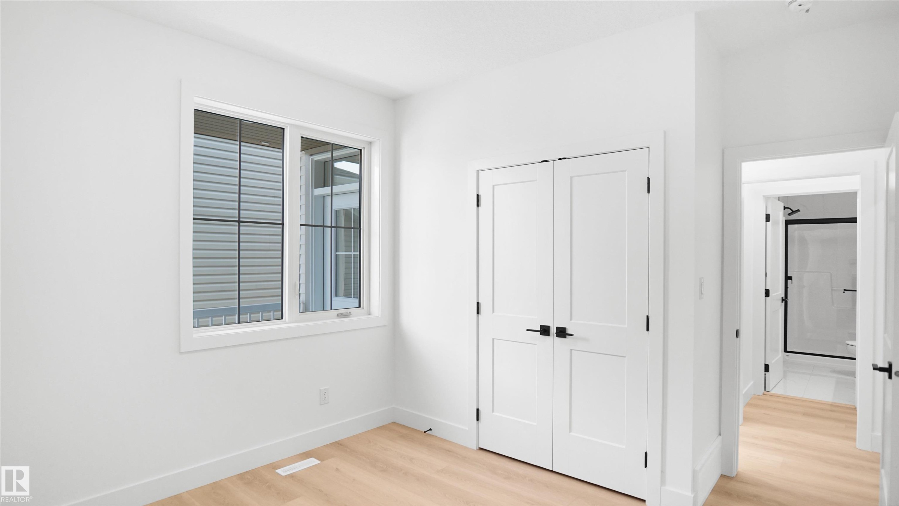 Unfurnished bedroom featuring light wood finished floors and a closet - 807 30 Avenue, Edmonton, AB - Indoor Photo Showing Other Room