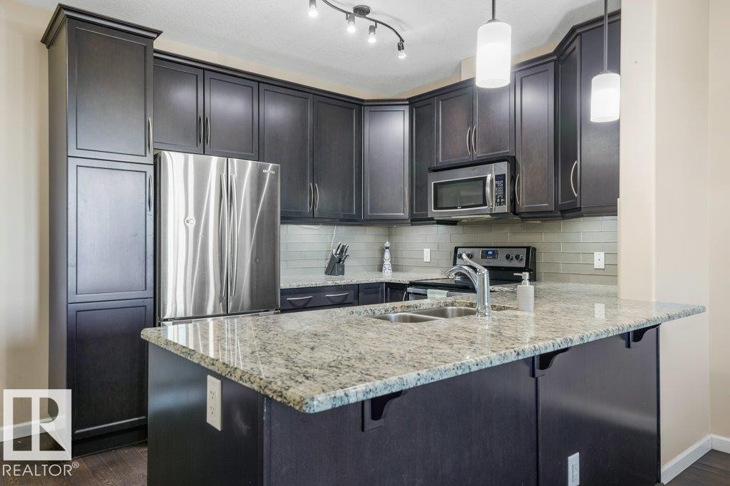 217 6083 Maynard Way, Edmonton, AB - Indoor Photo Showing Kitchen With Stainless Steel Kitchen With Double Sink With Upgraded Kitchen