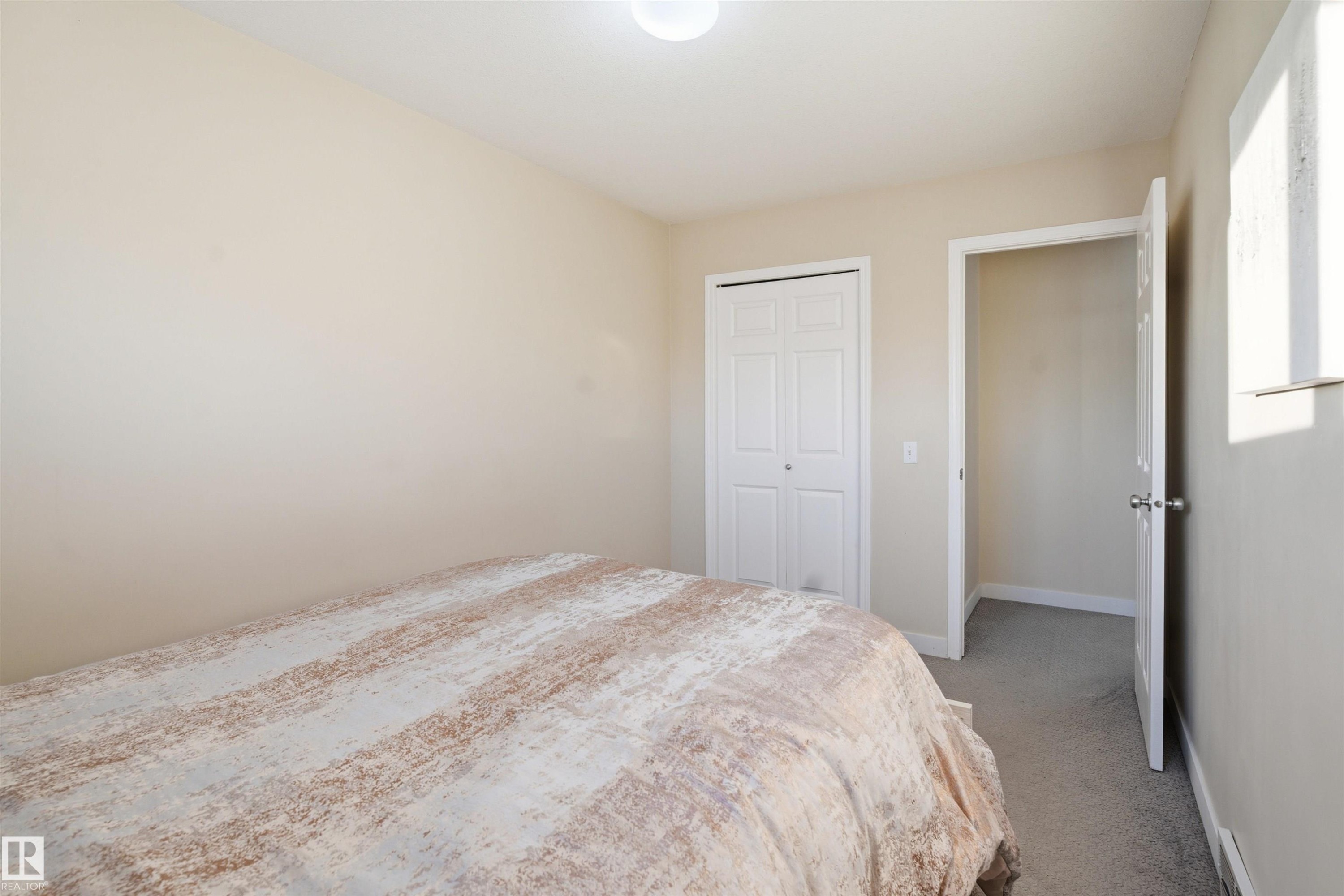 Bedroom with carpet flooring and a closet - 8 230 Edwards Drive, Edmonton, AB - Indoor Photo Showing Bedroom