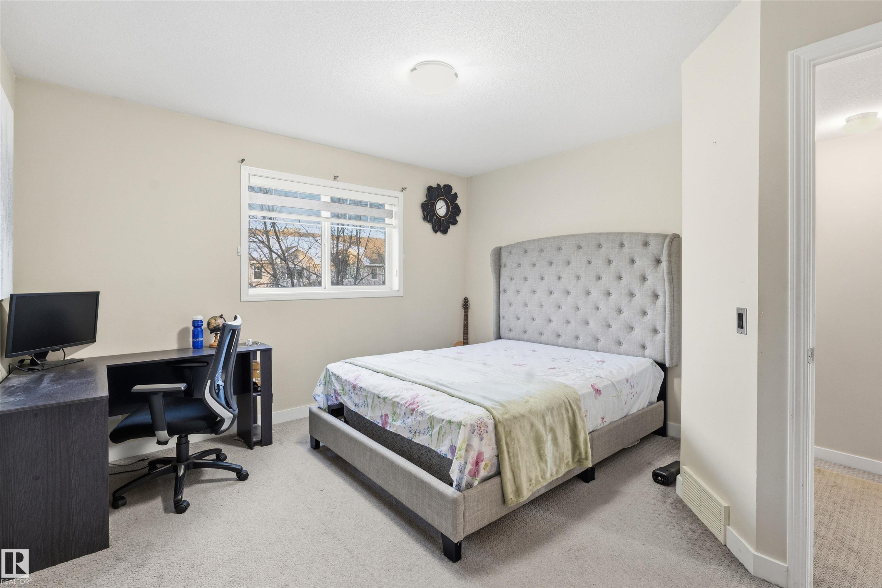 Bedroom featuring light colored carpet and a desk - 8 230 Edwards Drive, Edmonton, AB - Indoor Photo Showing Bedroom