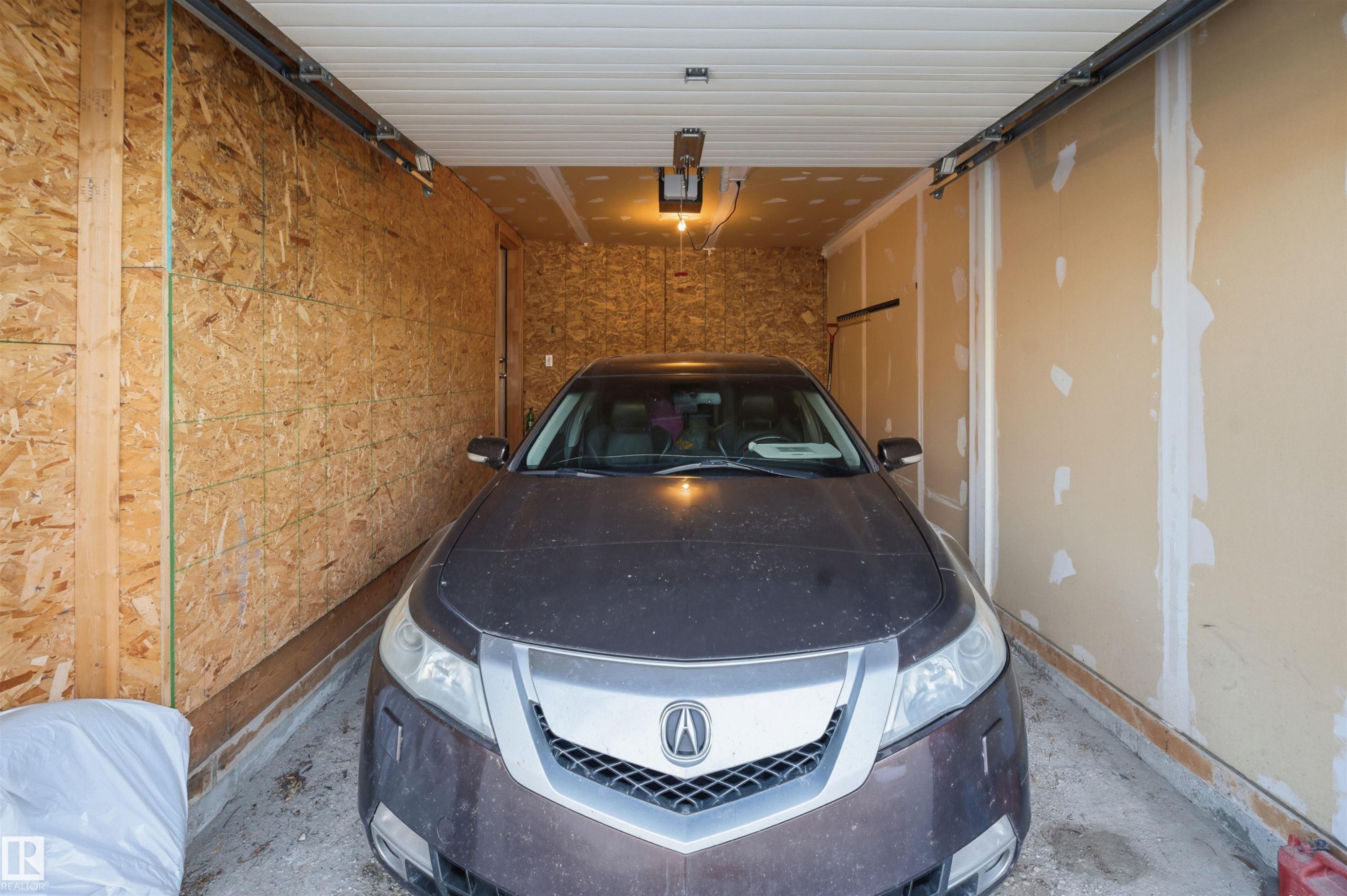 View of garage - 8 230 Edwards Drive, Edmonton, AB - Indoor Photo Showing Garage