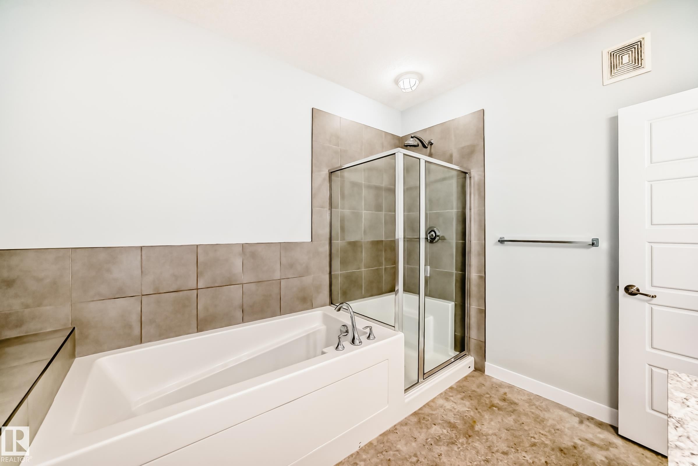 Bathroom featuring a garden tub and a shower stall - 201 2588 Anderson Way, Edmonton, AB - Indoor Photo Showing Bathroom