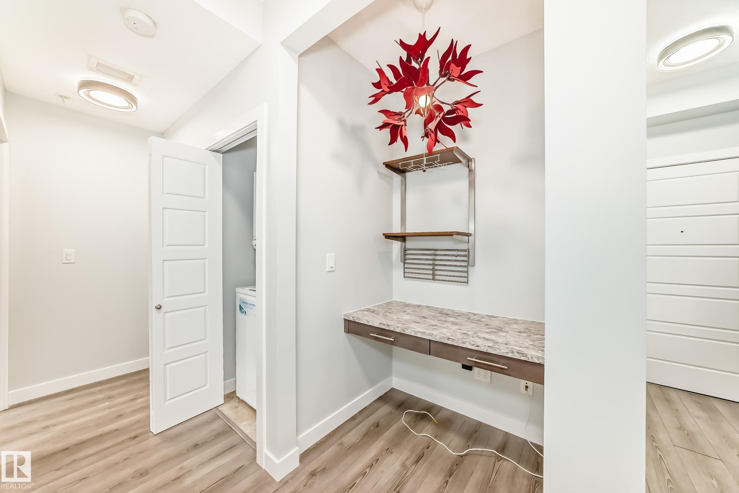 Corridor featuring light wood-type flooring and an office area - 201 2588 Anderson Way, Edmonton, AB - Indoor Photo Showing Other Room