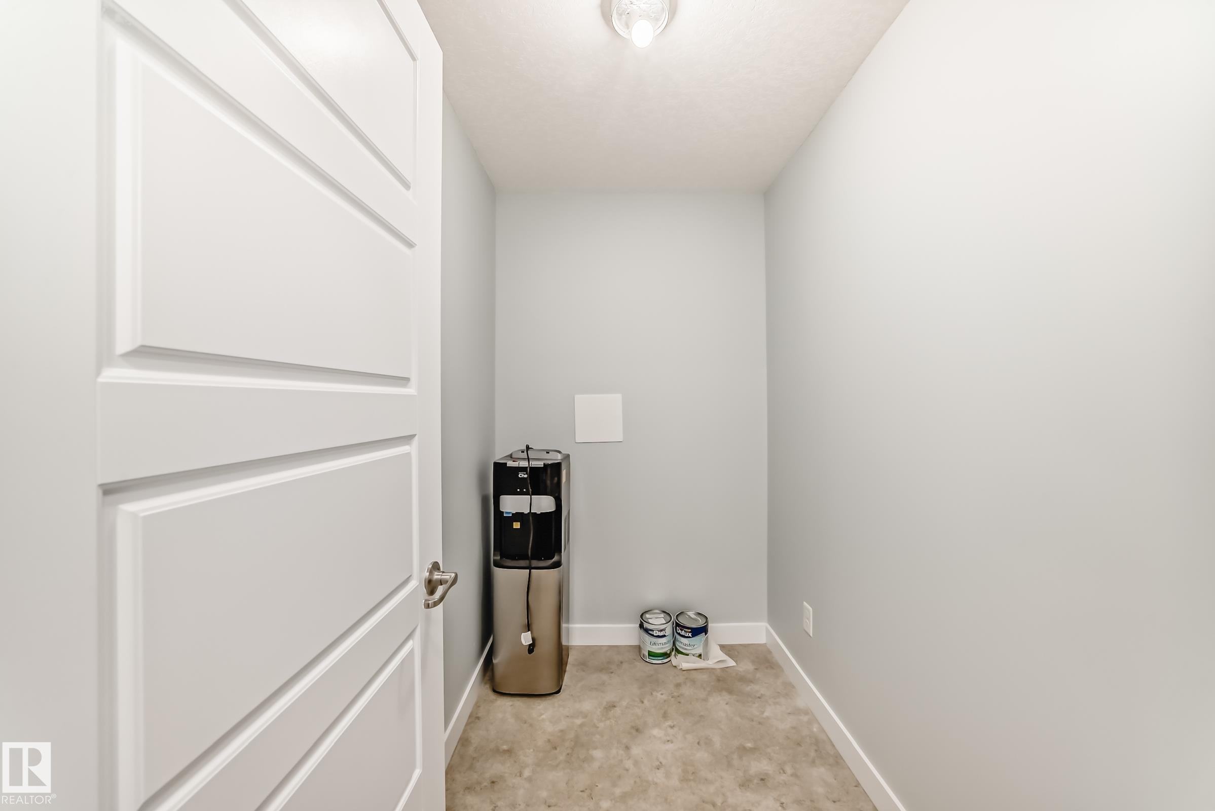 Laundry area with baseboards - 201 2588 Anderson Way, Edmonton, AB - Indoor Photo Showing Other Room