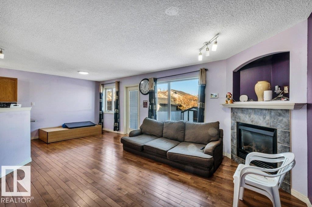 2144 37B Avenue, Edmonton, AB - Indoor Photo Showing Living Room With Fireplace