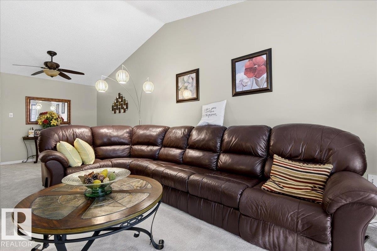 Carpeted living area featuring a ceiling fan and lofted ceiling - 13217 155 Avenue Nw, Edmonton, AB - Indoor Photo Showing Living Room