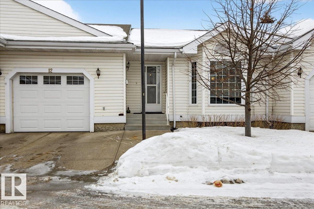 View of front of home featuring an attached garage and driveway - 13217 155 Avenue Nw, Edmonton, AB - Outdoor