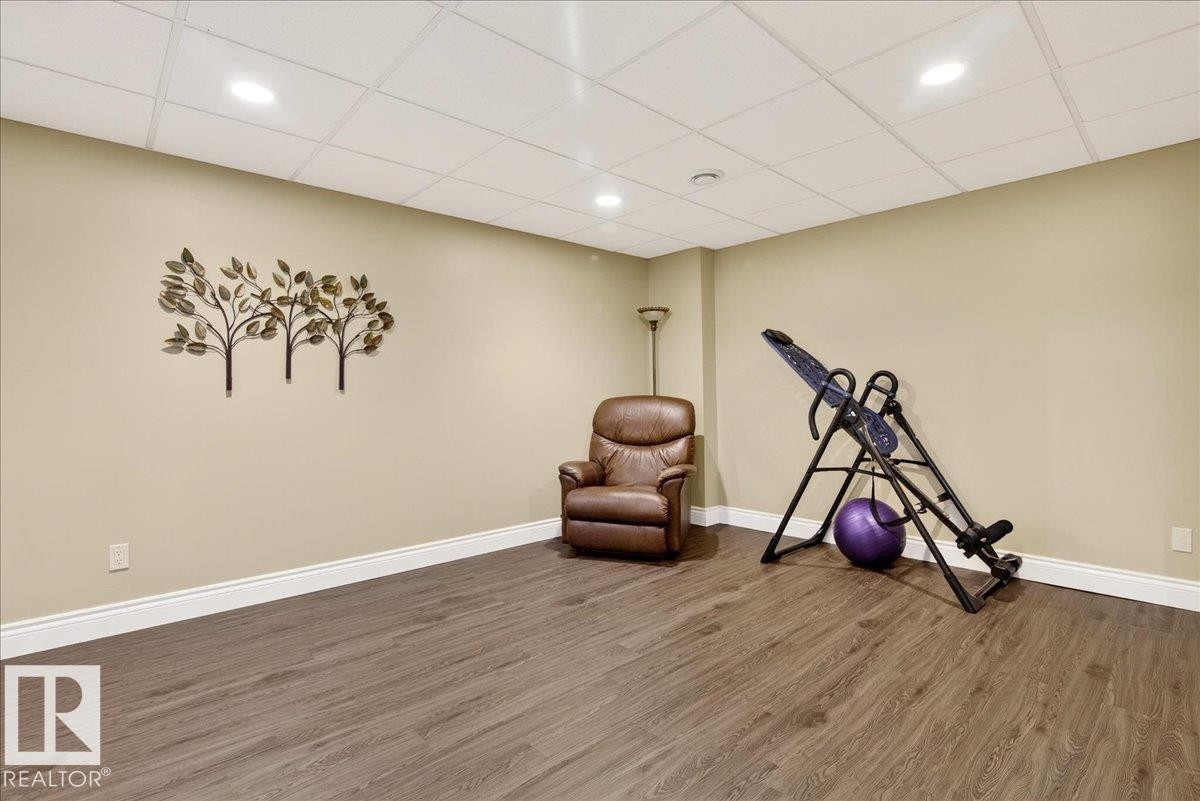 Exercise area featuring wood finished floors, a drop ceiling, and recessed lighting - 13217 155 Avenue Nw, Edmonton, AB - Indoor