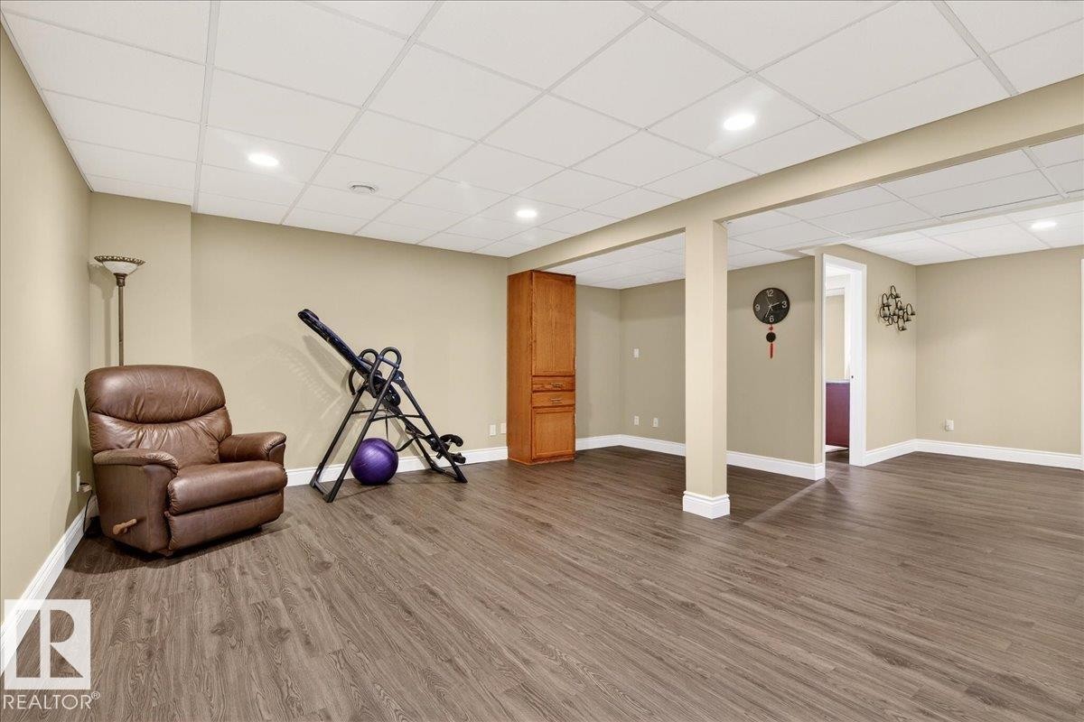 Workout room featuring wood finished floors, a paneled ceiling, and recessed lighting - 13217 155 Avenue Nw, Edmonton, AB - Indoor Photo Showing Other Room