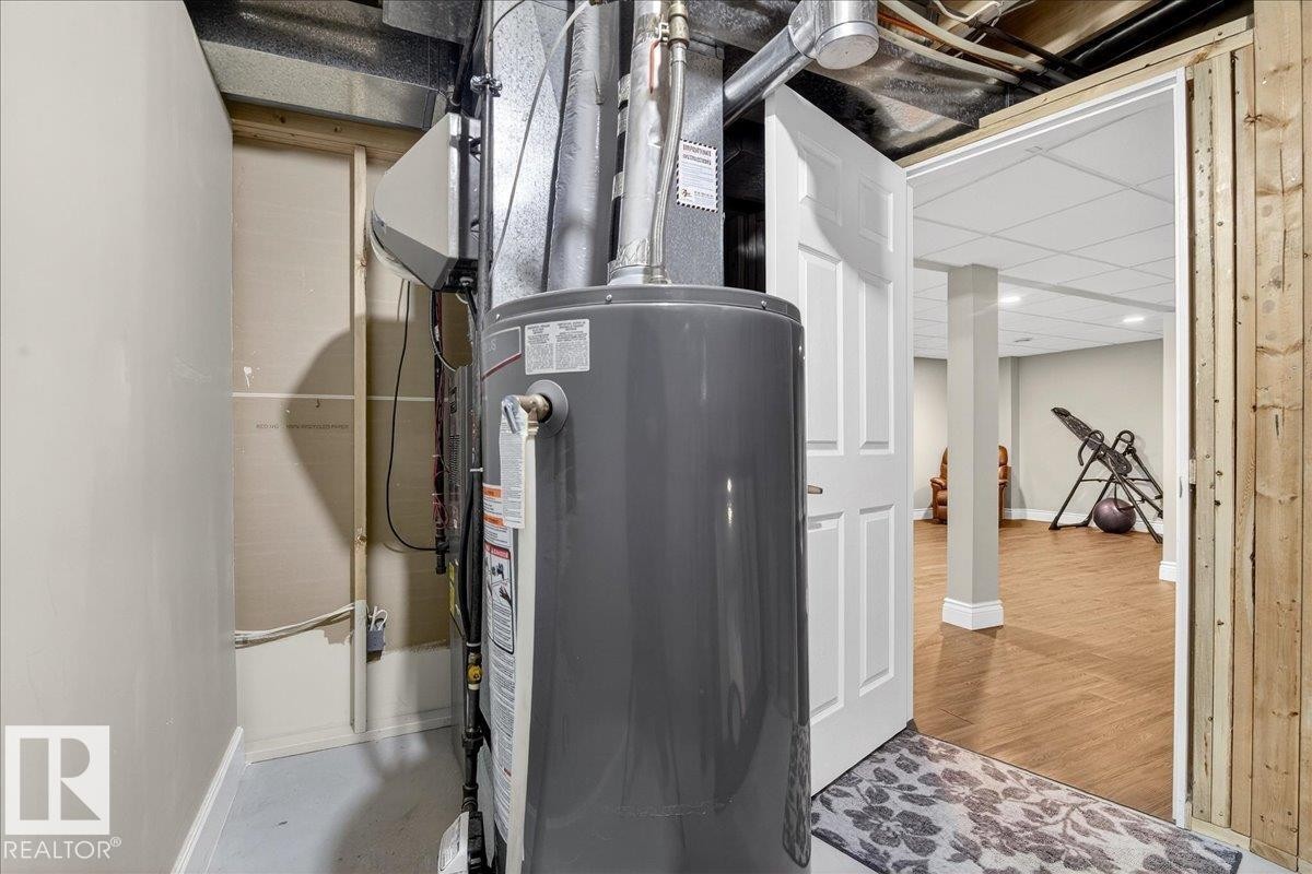 Utility room with gas water heater - 13217 155 Avenue Nw, Edmonton, AB - Indoor Photo Showing Basement