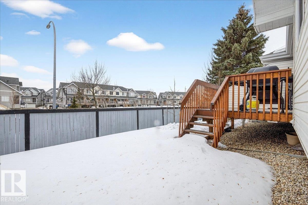 Fenced yard featuring a residential view and a deck - 13217 155 Avenue Nw, Edmonton, AB - Outdoor