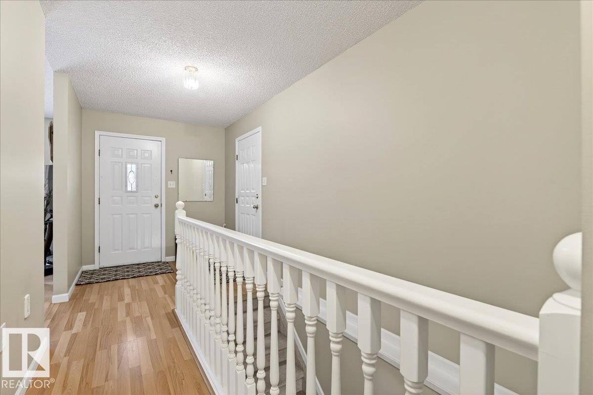 Entrance foyer featuring light wood-style flooring and a textured ceiling - 13217 155 Avenue Nw, Edmonton, AB - Indoor Photo Showing Other Room