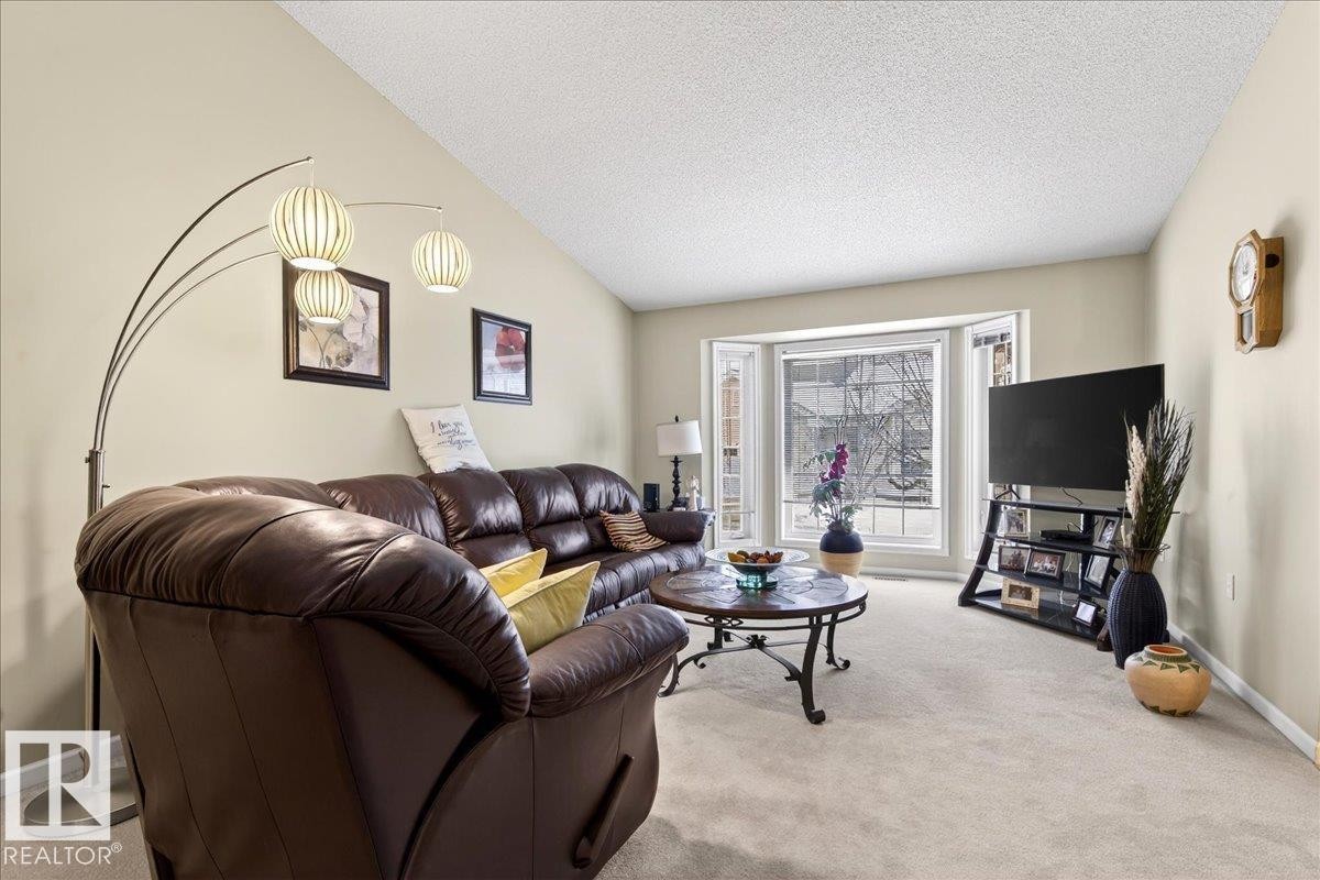 Living room with light carpet and baseboards - 13217 155 Avenue Nw, Edmonton, AB - Indoor Photo Showing Living Room