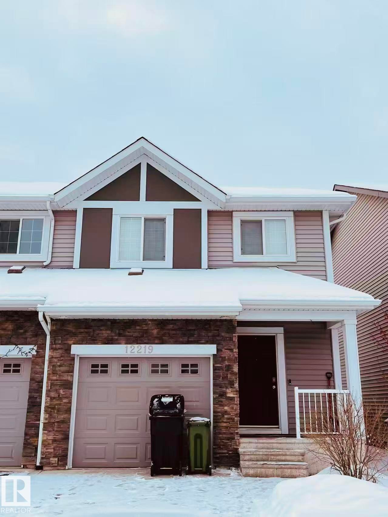 Traditional-style house with stone siding, a porch, and an attached garage - 12219 167A Avenue, Edmonton, AB - Outdoor