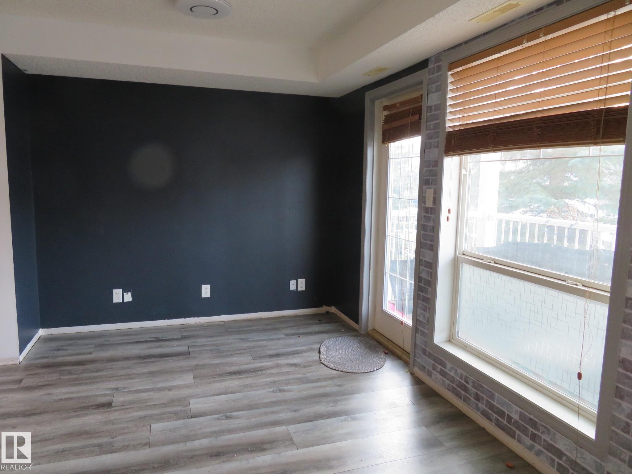 Spare room featuring light wood-style floors and a tray ceiling - 2945 26 Street, Edmonton, AB - Indoor Photo Showing Other Room