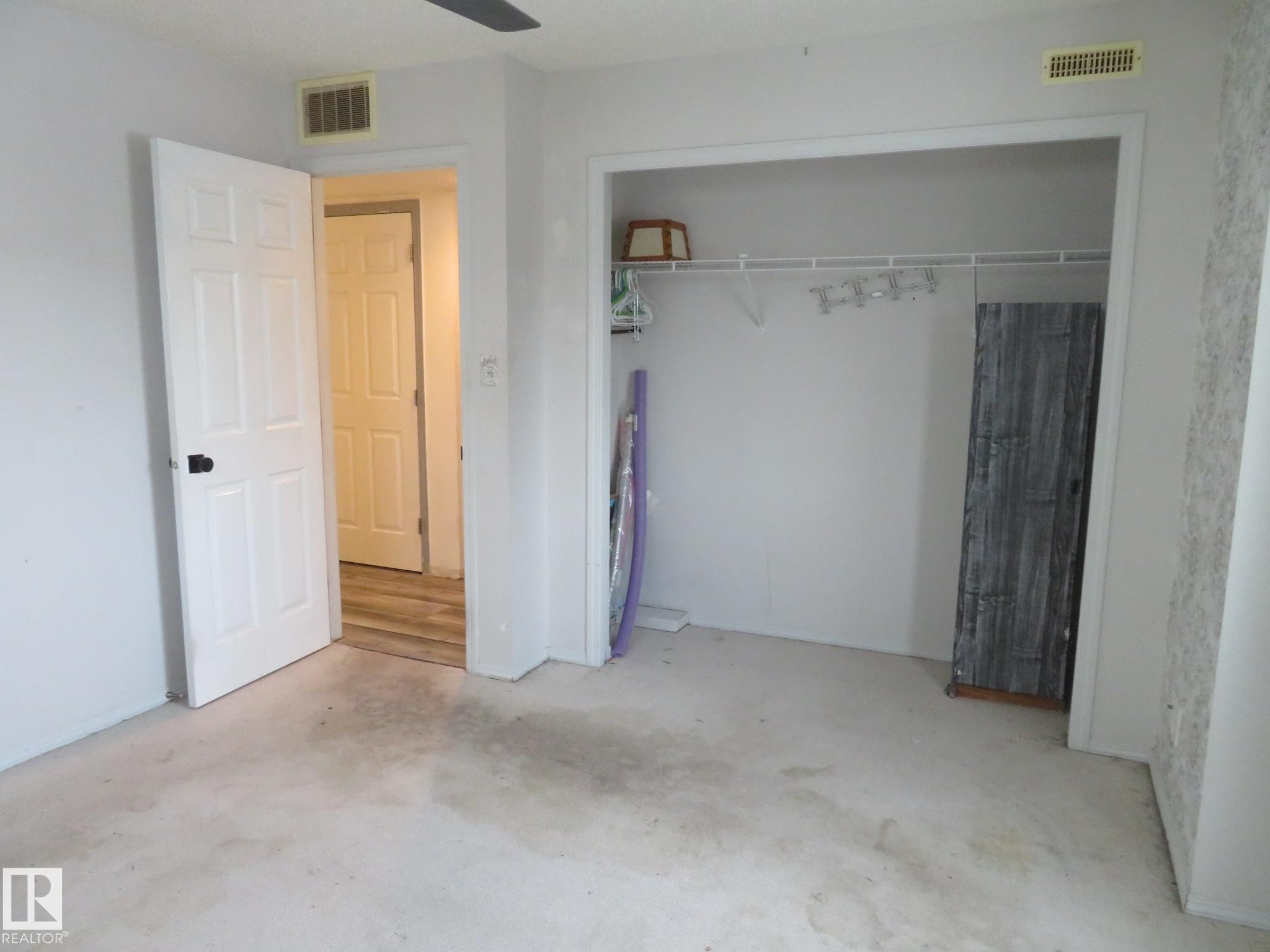 Unfurnished bedroom with a closet and concrete floors - 2945 26 Street, Edmonton, AB - Indoor