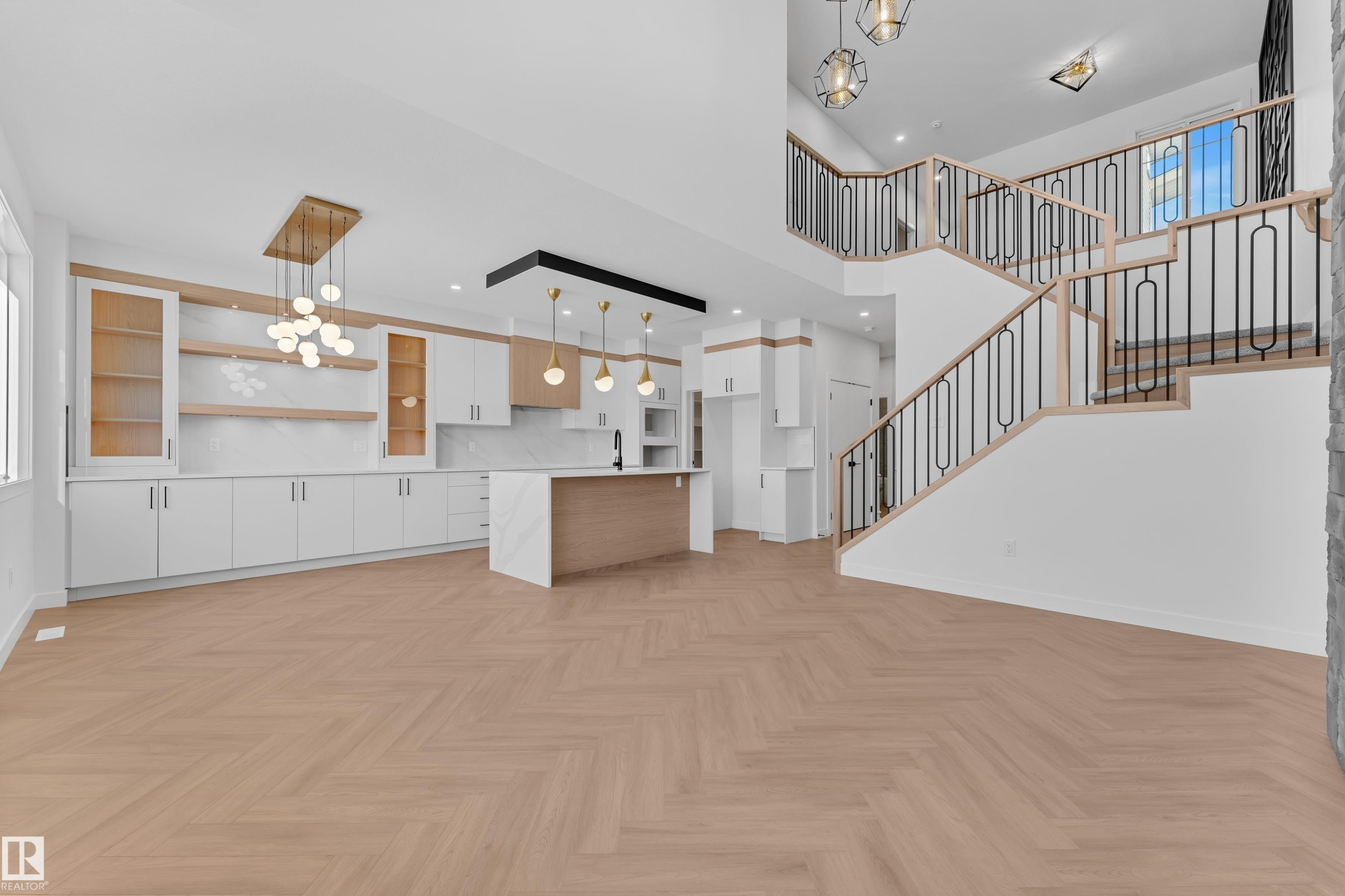 Kitchen featuring white cabinets, open floor plan, a chandelier, parquet flooring, and a high ceiling - 38 Grayson Green, Stony Plain, AB - Indoor Photo Showing Kitchen
