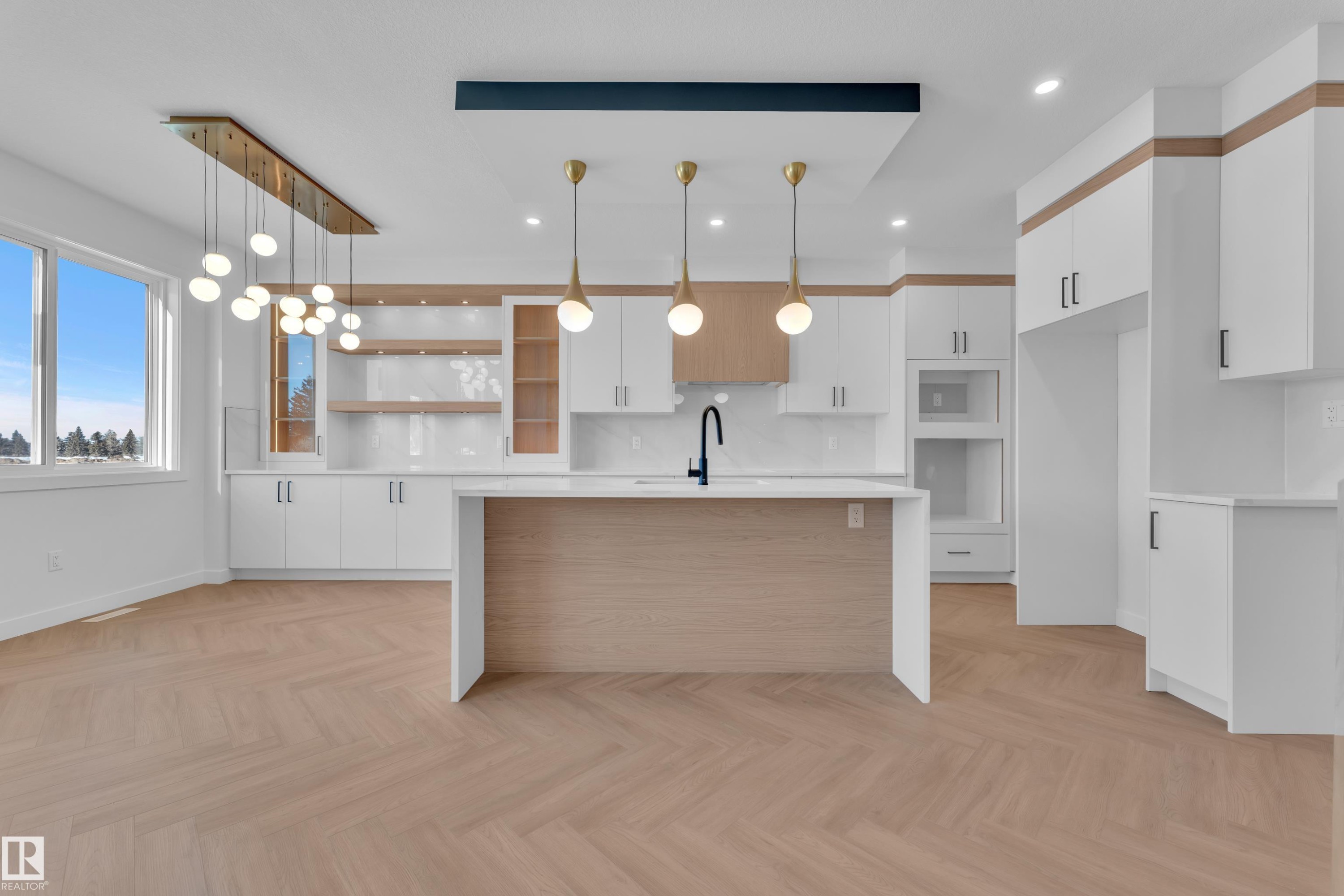 Kitchen with open shelves, white cabinets, hanging light fixtures, and a breakfast bar - 38 Grayson Green, Stony Plain, AB - Indoor Photo Showing Kitchen