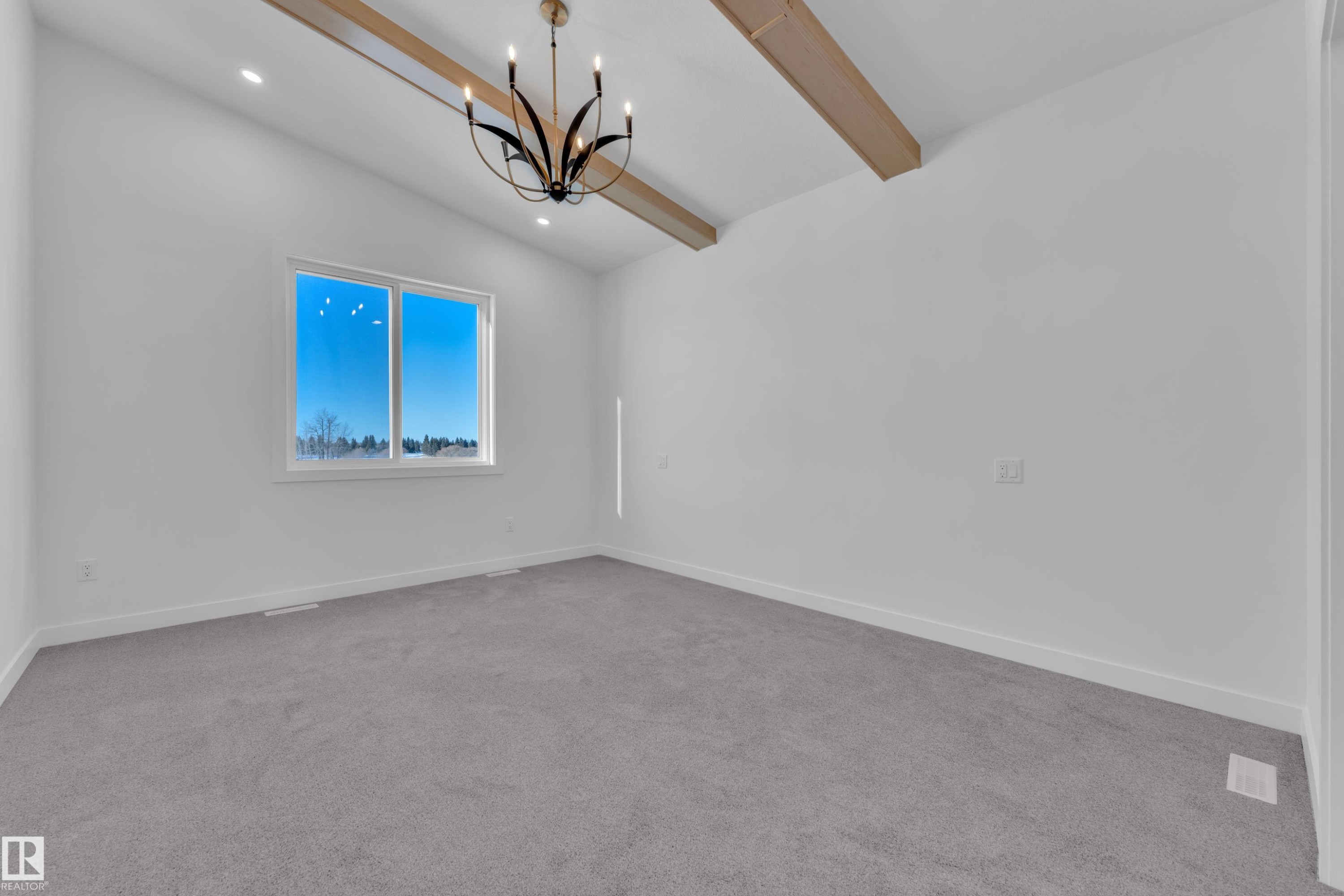 Unfurnished room with light carpet, suspended lighting, and vaulted ceiling with beams - 38 Grayson Green, Stony Plain, AB - Indoor Photo Showing Other Room