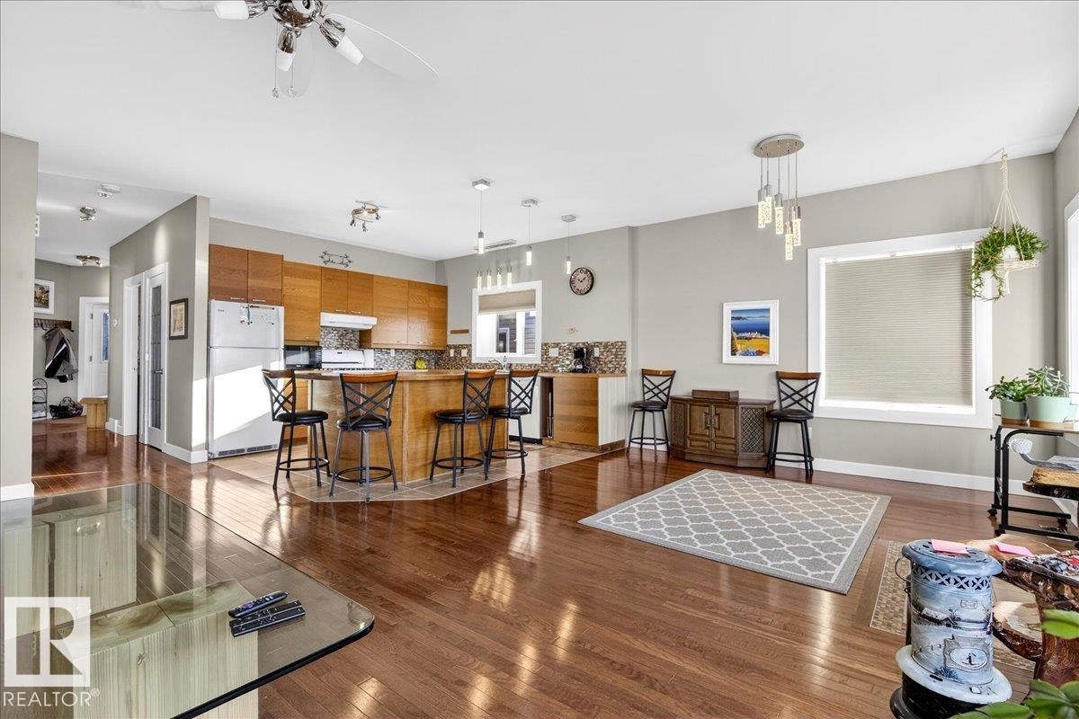 Living room featuring ceiling fan and dark wood finished floors - 5019 48 Avenue, Chipman, AB - Indoor Photo Showing Living Room