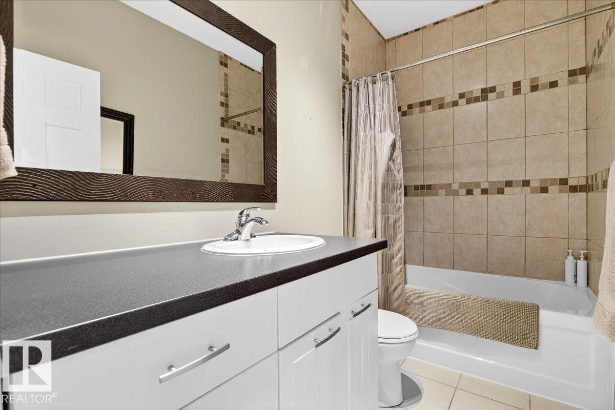 Bathroom with shower / tub combo, vanity, and light tile patterned floors - 5019 48 Avenue, Chipman, AB - Indoor Photo Showing Bathroom