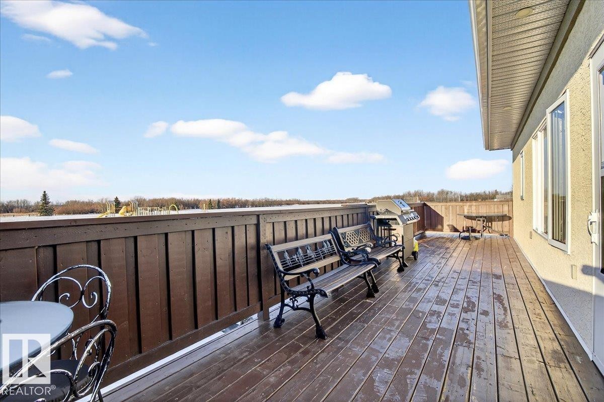 Wooden deck with outdoor dining area and grilling area - 5019 48 Avenue, Chipman, AB - Outdoor With Deck Patio Veranda
