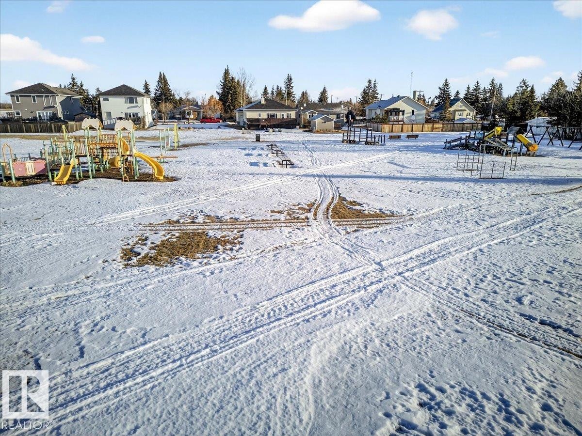 Yard layered in snow with a residential view - 5019 48 Avenue, Chipman, AB - Outdoor