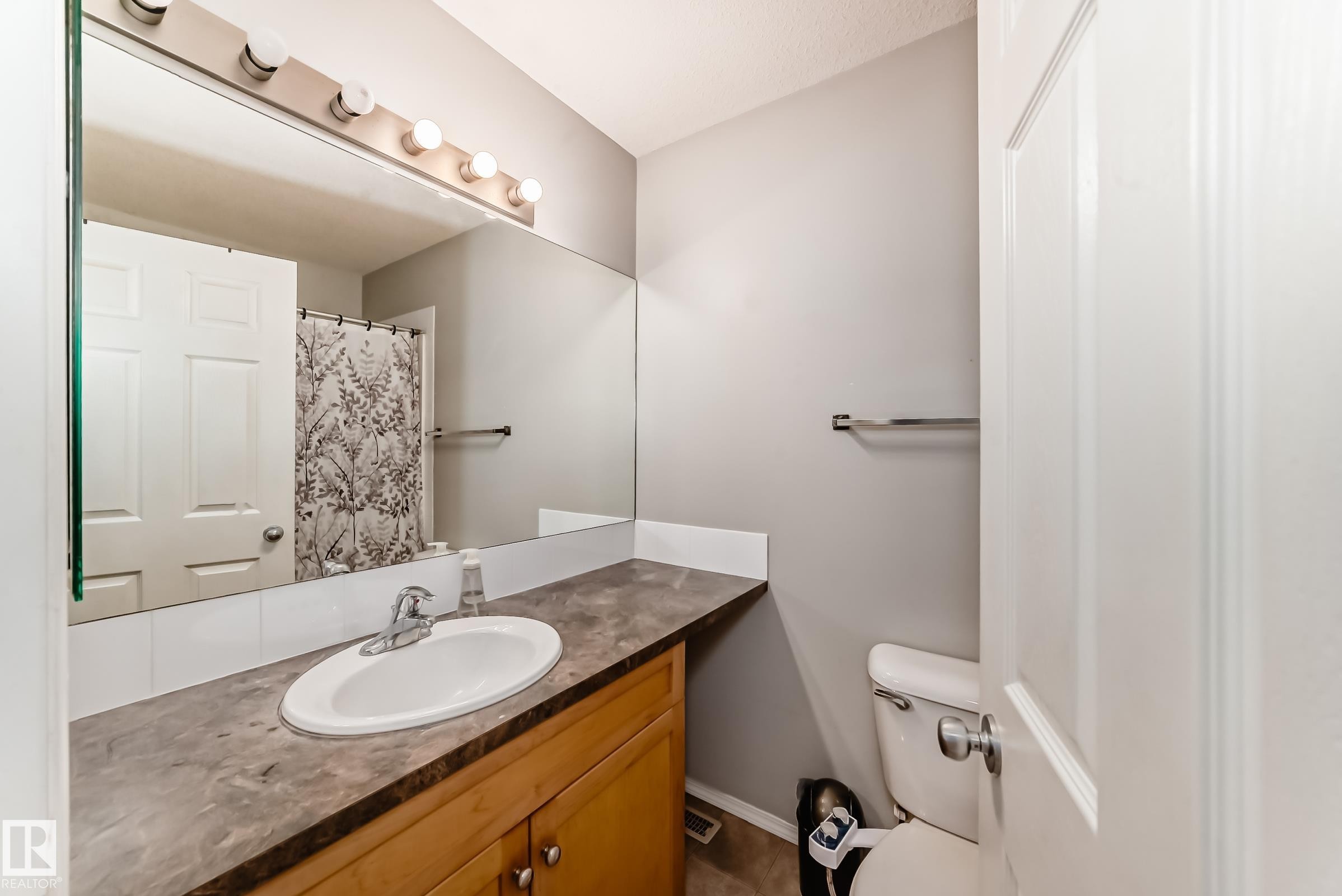 Full bath with a shower with shower curtain and vanity - 185 230 Edwards Drive, Edmonton, AB