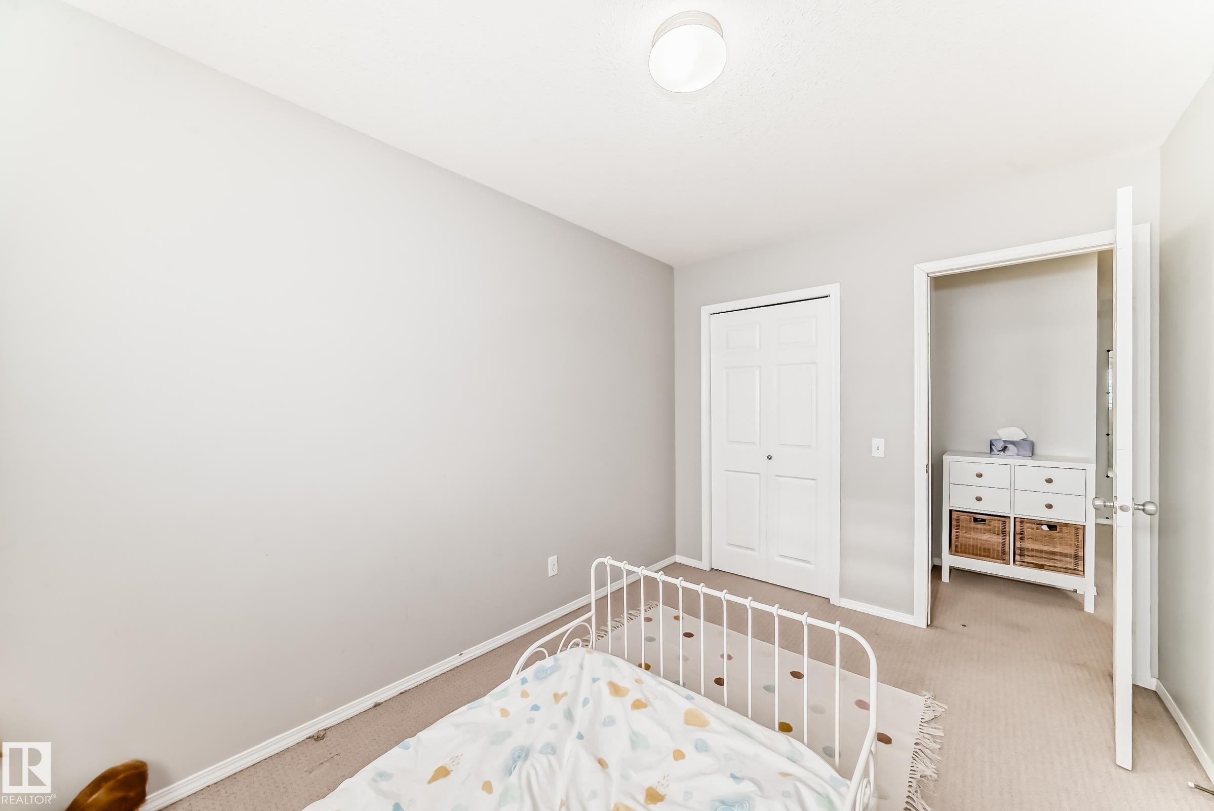 Bedroom with carpet flooring and a closet - 185 230 Edwards Drive, Edmonton, AB