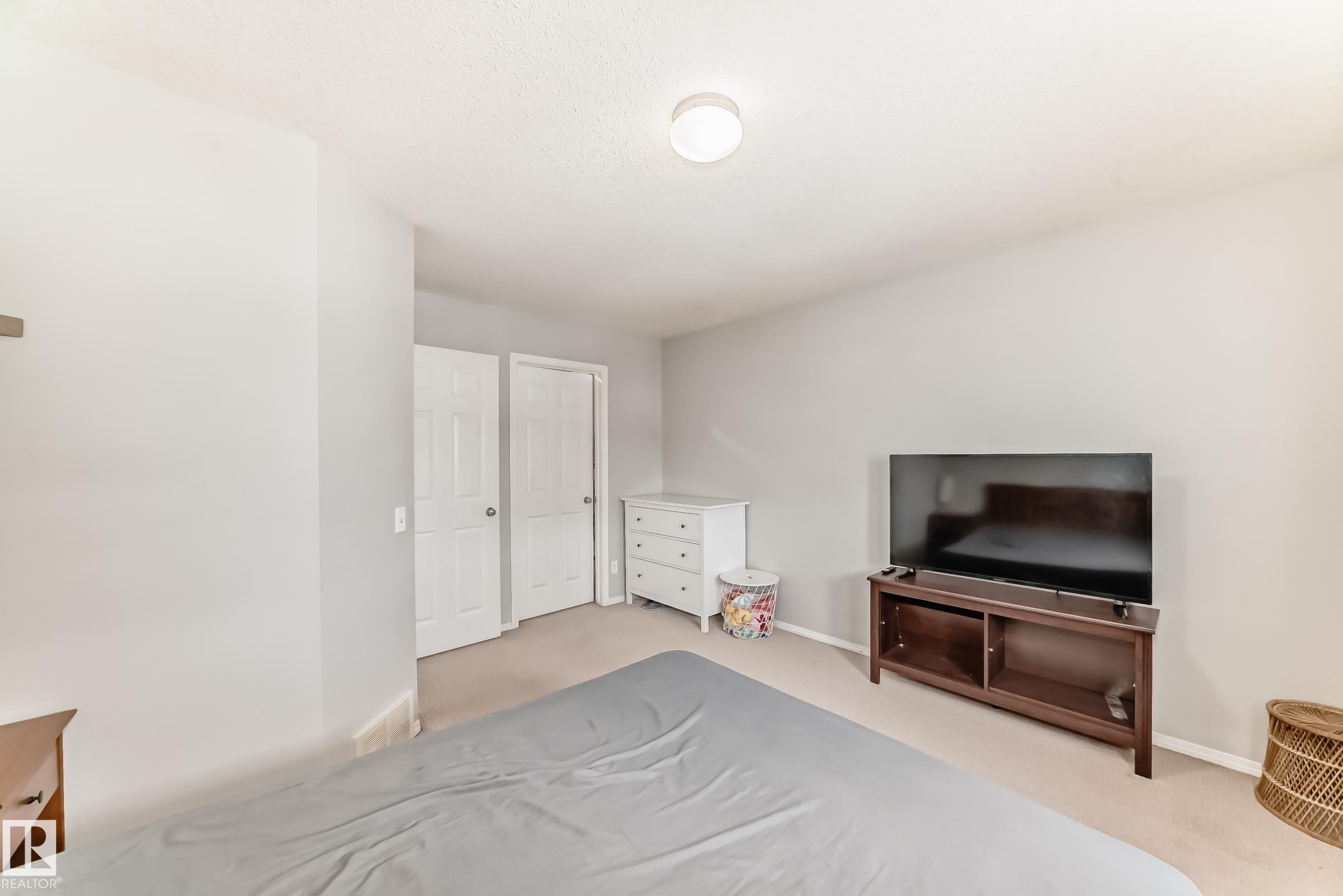 Bedroom featuring carpet flooring and baseboards - 185 230 Edwards Drive, Edmonton, AB