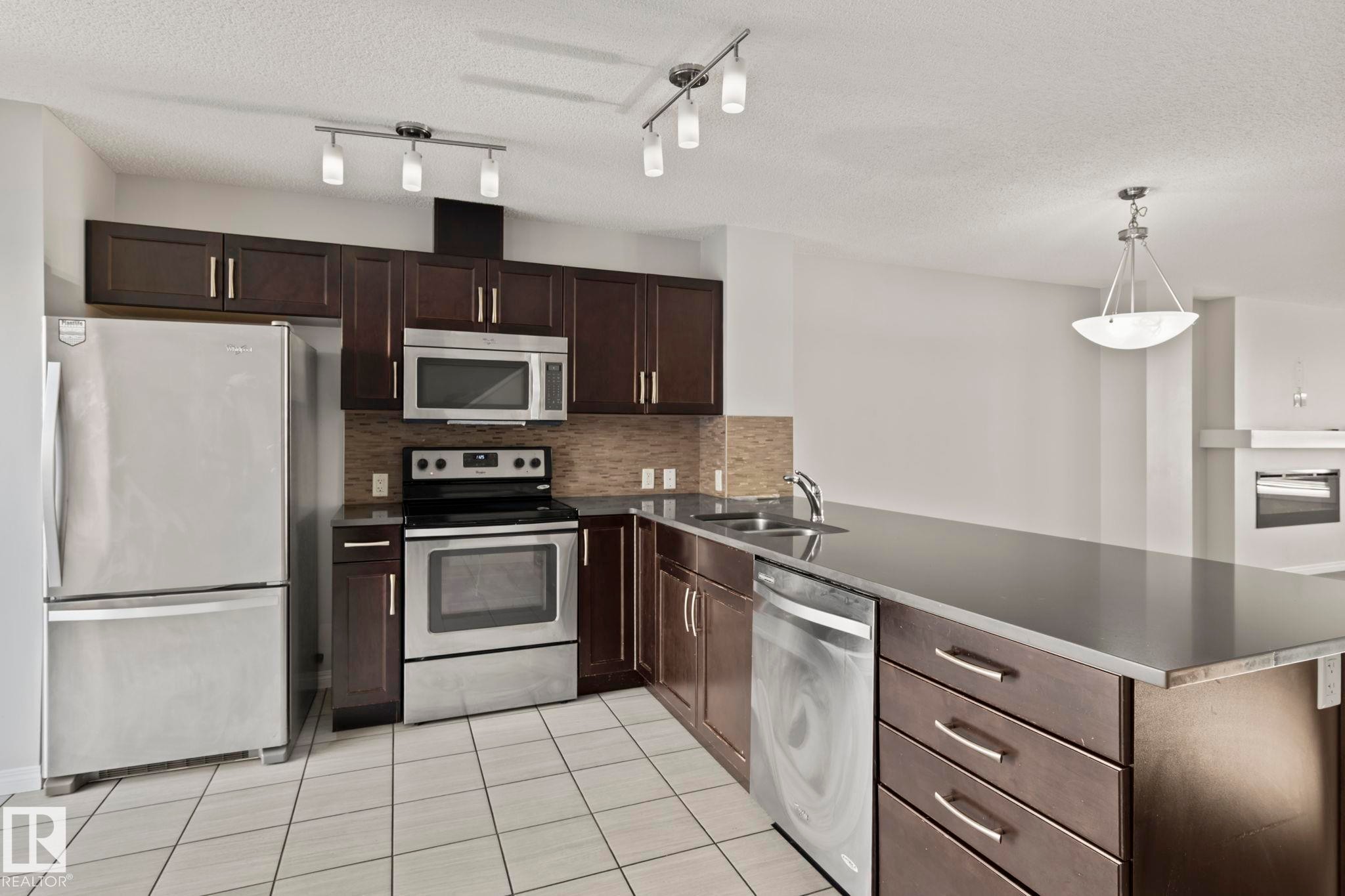 #62 4050 Savaryn Drive Sw, Edmonton, AB - Indoor Photo Showing Kitchen With Double Sink