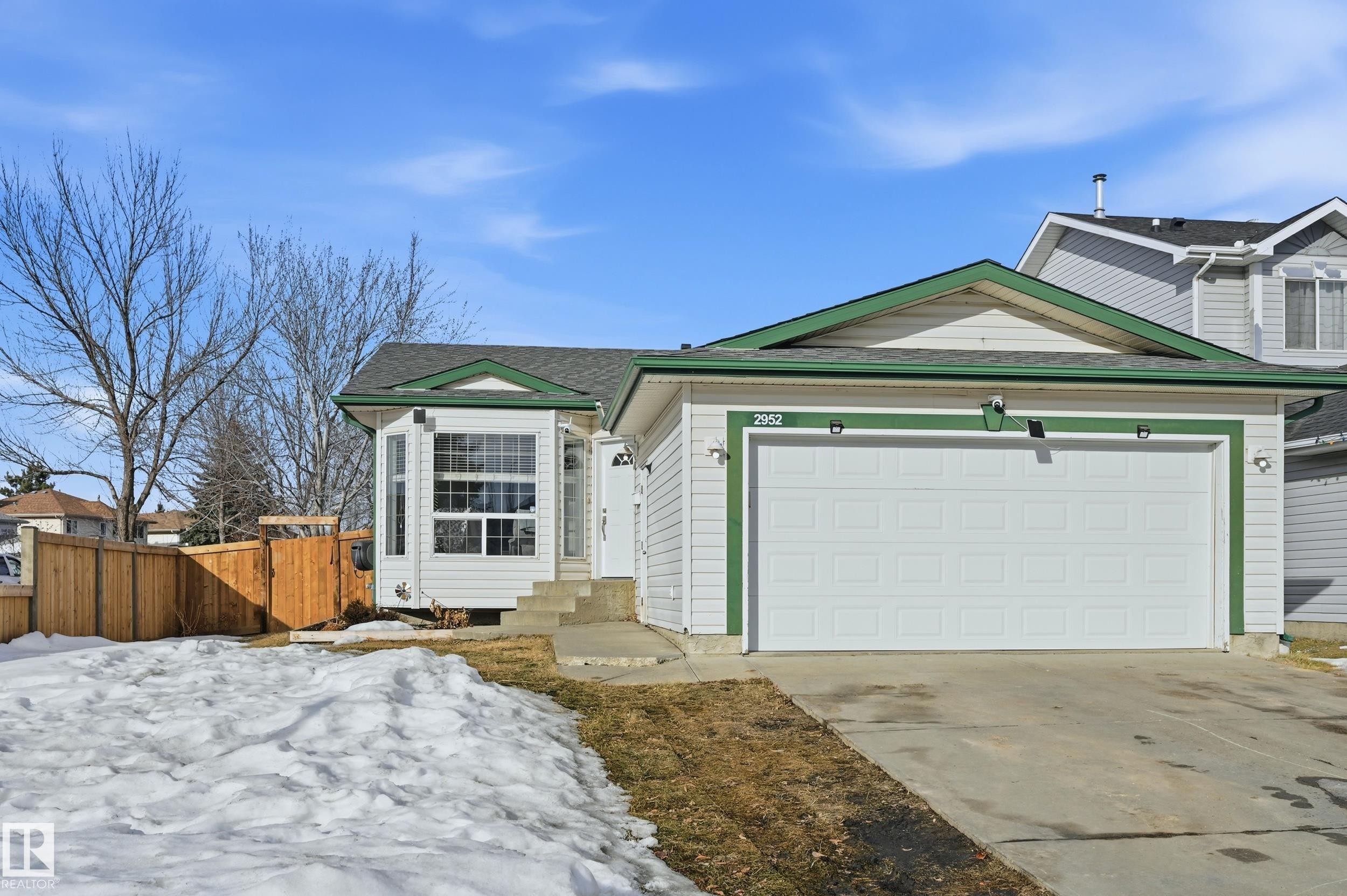 View of front of home with driveway, an attached garage, and roof with shingles - 2952 39 Avenue, Edmonton, AB - Outdoor